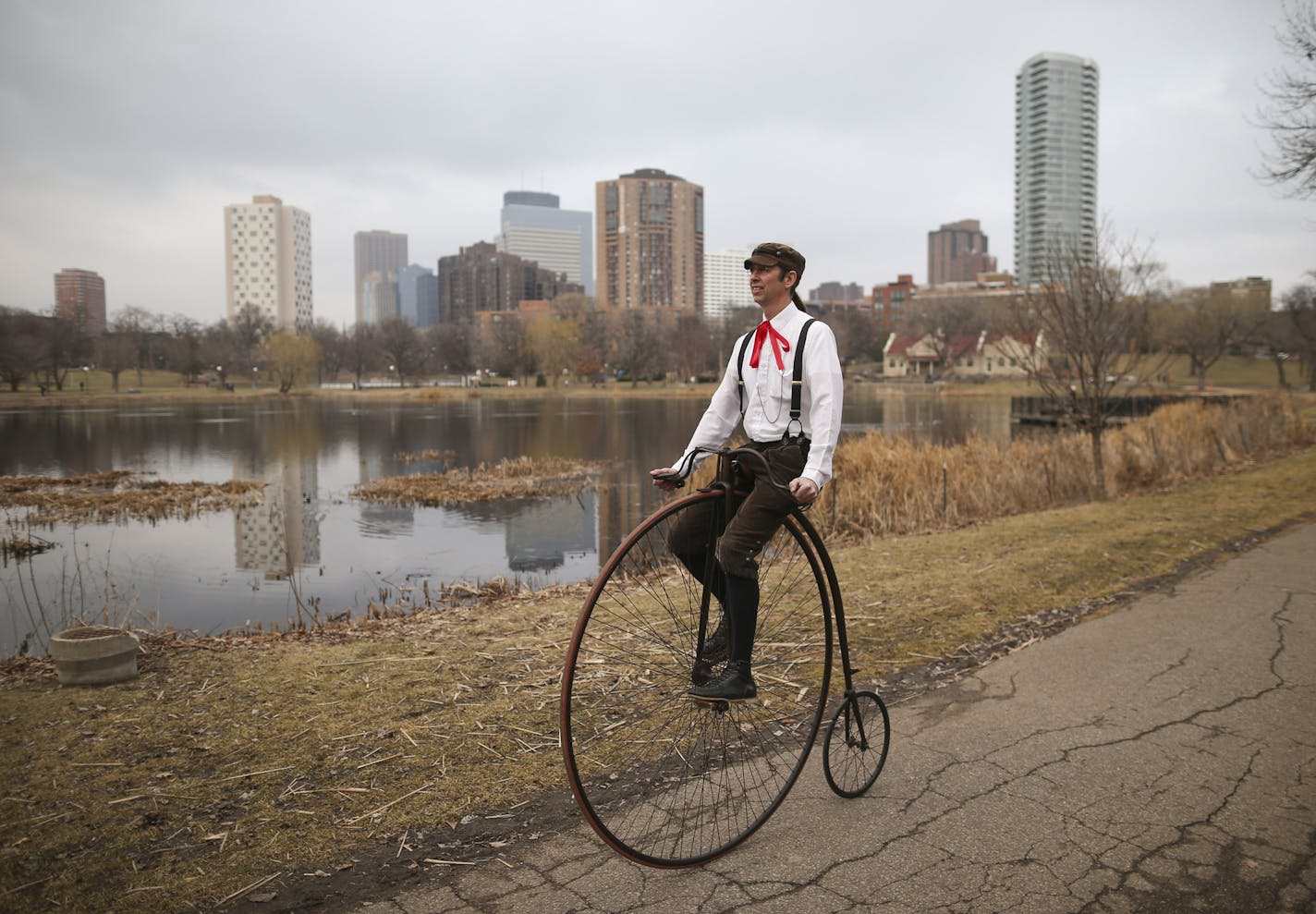 Bicycle enthusiast Juston Anderson rides an 1890 Victor high wheeler bicycle in Loring Park.