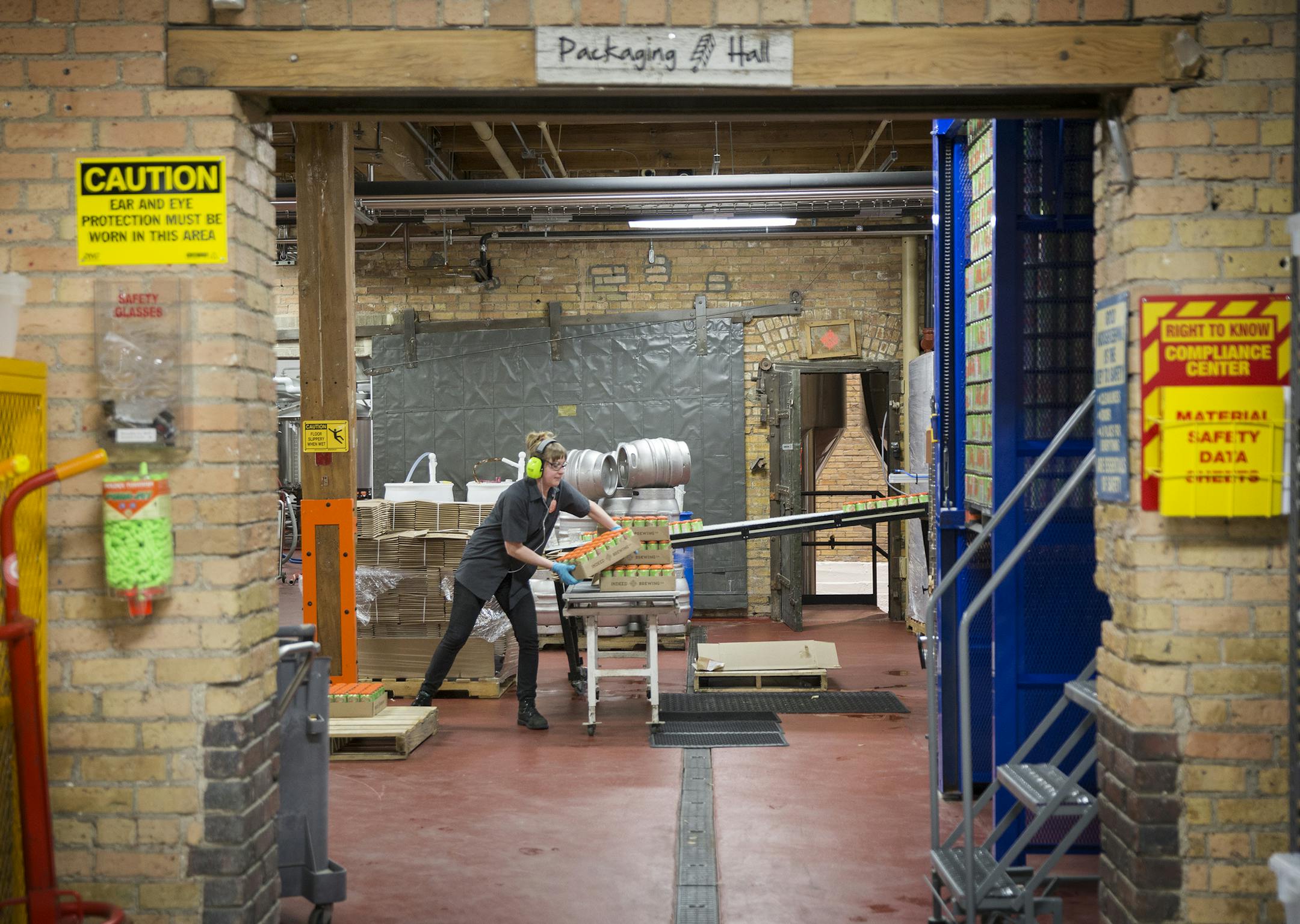 Kristine Volovsek packs up cans of beer at Indeed Brewery in Minneapolis on Thursday, March 26, 2015. ] LEILA NAVIDI leila.navidi@startribune.com /
