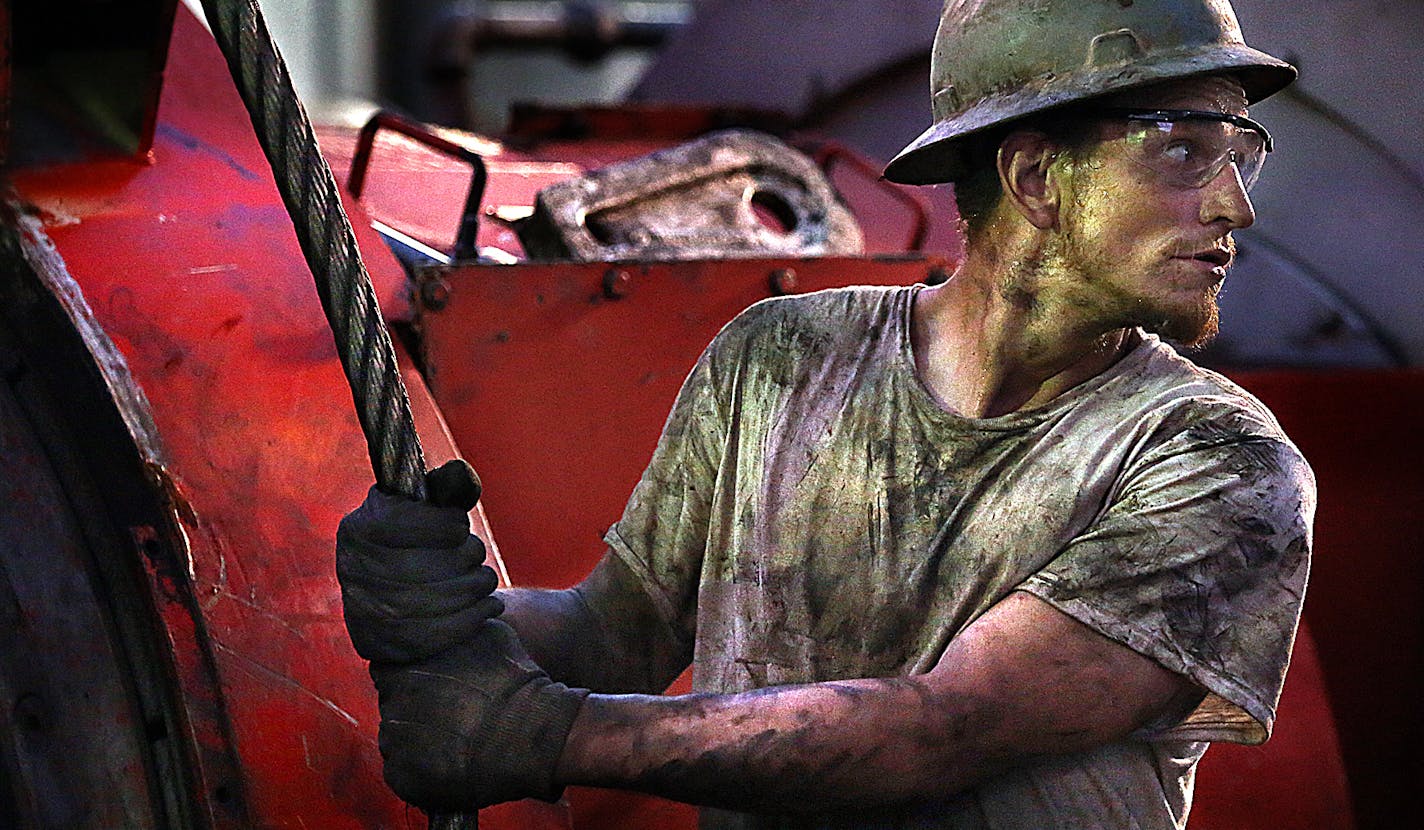 Floor hand Ray Gerrish worked to make repairs on a drilling rig as the sun rose near the site outside Watford City. ] (JIM GEHRZ/STAR TRIBUNE) / December 17, 2013, Watford City, ND &#x201a;&#xc4;&#xec; BACKGROUND INFORMATION- PHOTOS FOR USE IN FINAL PART OF NORTH DAKOTA OIL BOOM PROJECT: Men work around the clock at Raven Rig No. 1 near Watford City, one of nearly 200 towering oil rigs in the Bakken. Once the rigs drill holes, several miles deep and then several miles horizontally, hydraulic fra