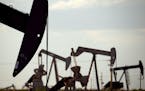 FILE - In this April 24, 2015, file photo, pumpjacks work in a field near Lovington, N.M. Oil industry and environmental groups say they expect the En