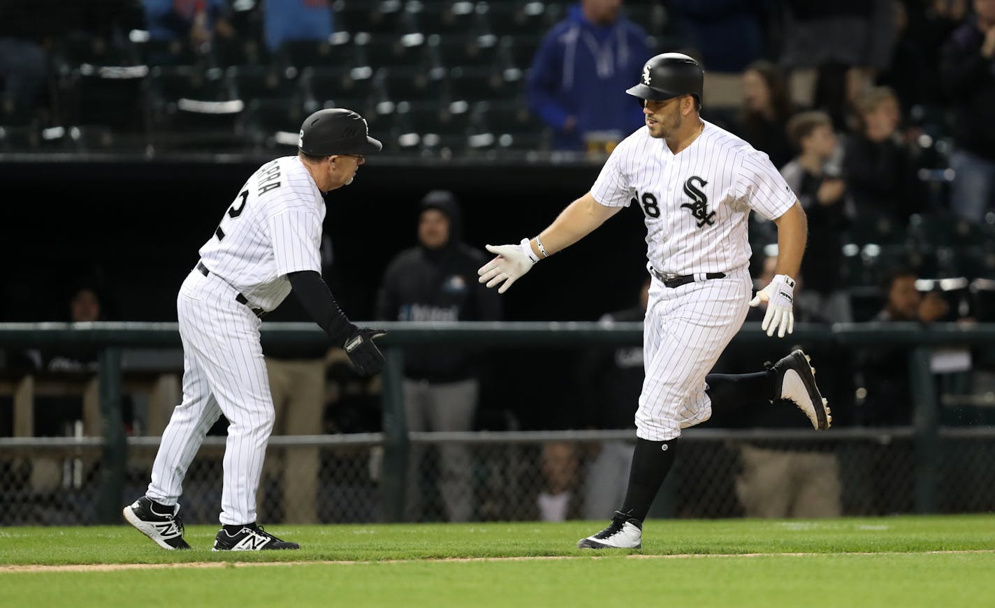 Daniel Palka is congratulated by third base coach Nick Capra after Palka hit a two-run home run in the fourth inning against the Twins