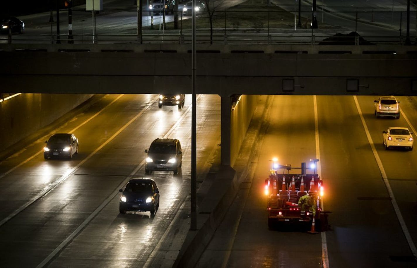 A man dropped safety cones on the road to shut down a lane of eastbound I-94 thru the Lowry Hill Tunnel Wednesday night in Minneapolis, Minn., on March 22, 2017.