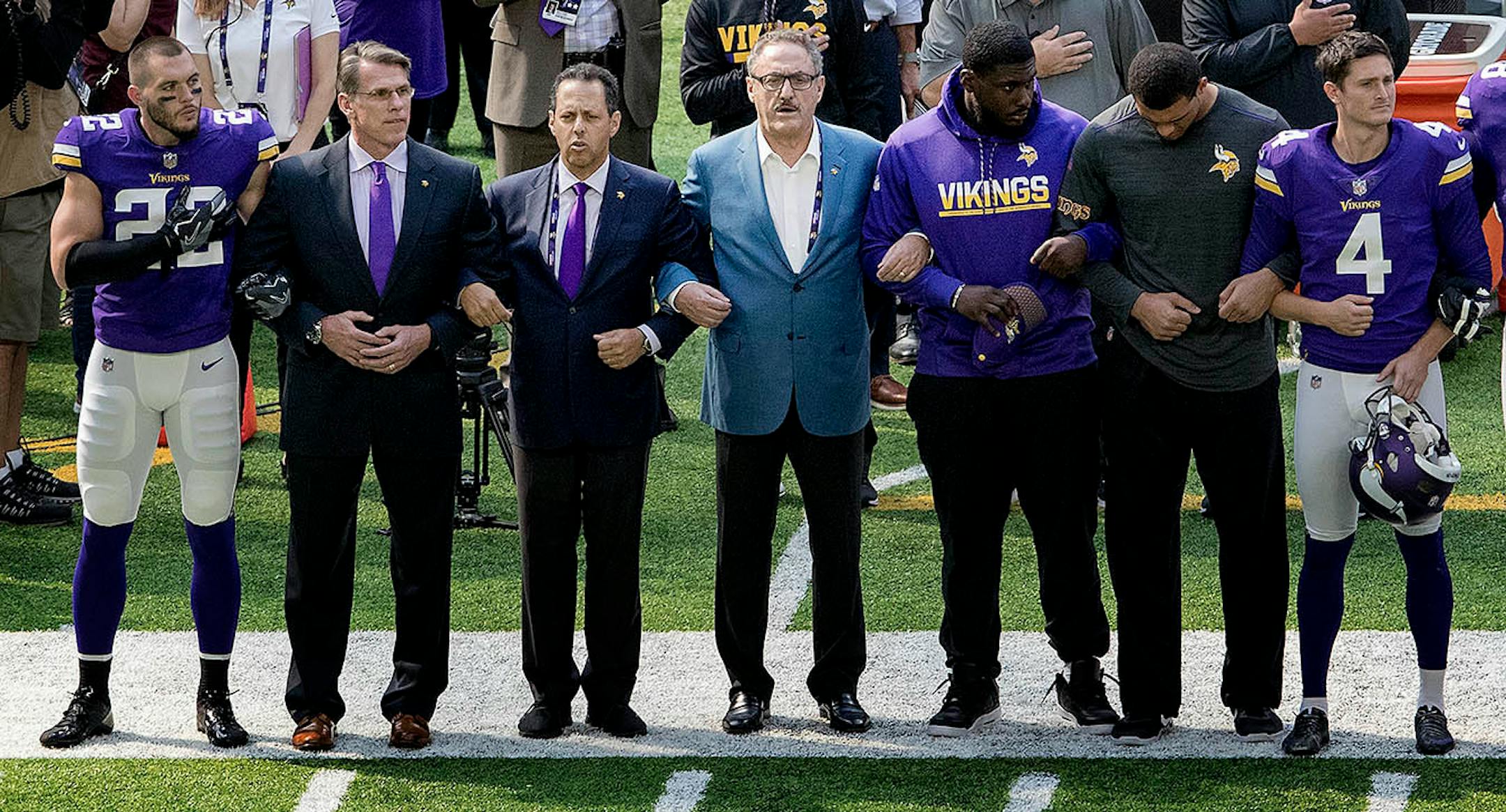 Minnesota Vikings general manager Rick Spielman, owners Mark Wilf and Zygi Wilf stood with players Harrison Smith (22) (left) during the National Anthem before the start of a game vs. the Tampa Bay Buccaneers at US Bank Stadium.