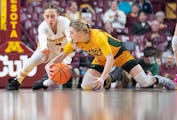 Gophers guard Amaya Battle, left, fights for a loose ball against North Dakota State's Heaven Hamling in a WNIT Super 16 game at Williams Arena on Mar