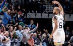 Jordan McLaughlin celebrated a three-pointer with fans during Monday’s victory over Miami at Target Center.