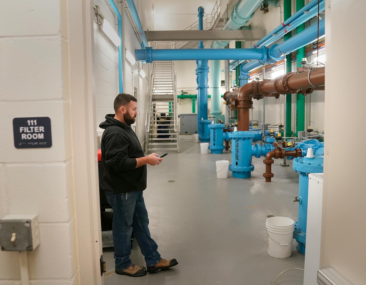 Derek Cavanaugh, an Elko New Market public works maintenance employee, monitors the pipe gallery in the Elko New Market water treatment facility.