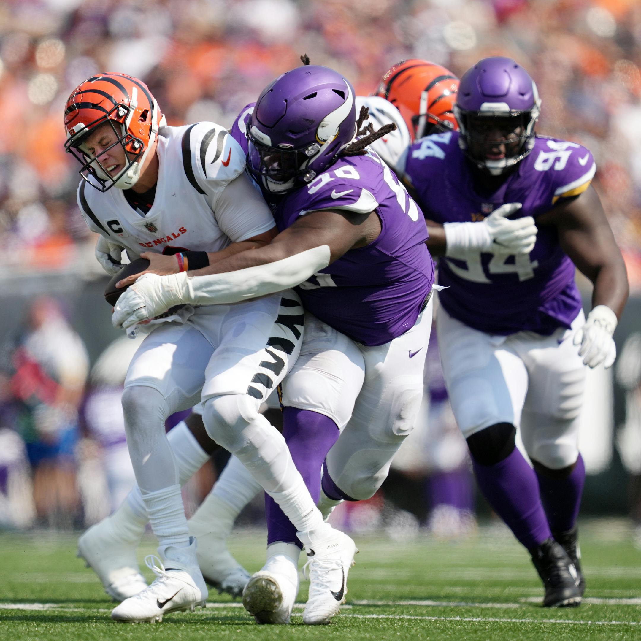 Cincinnati Bengals quarterback Joe Burrow (9) was sacked by Minnesota Vikings defensive tackle Michael Pierce (58) in the third quarter.