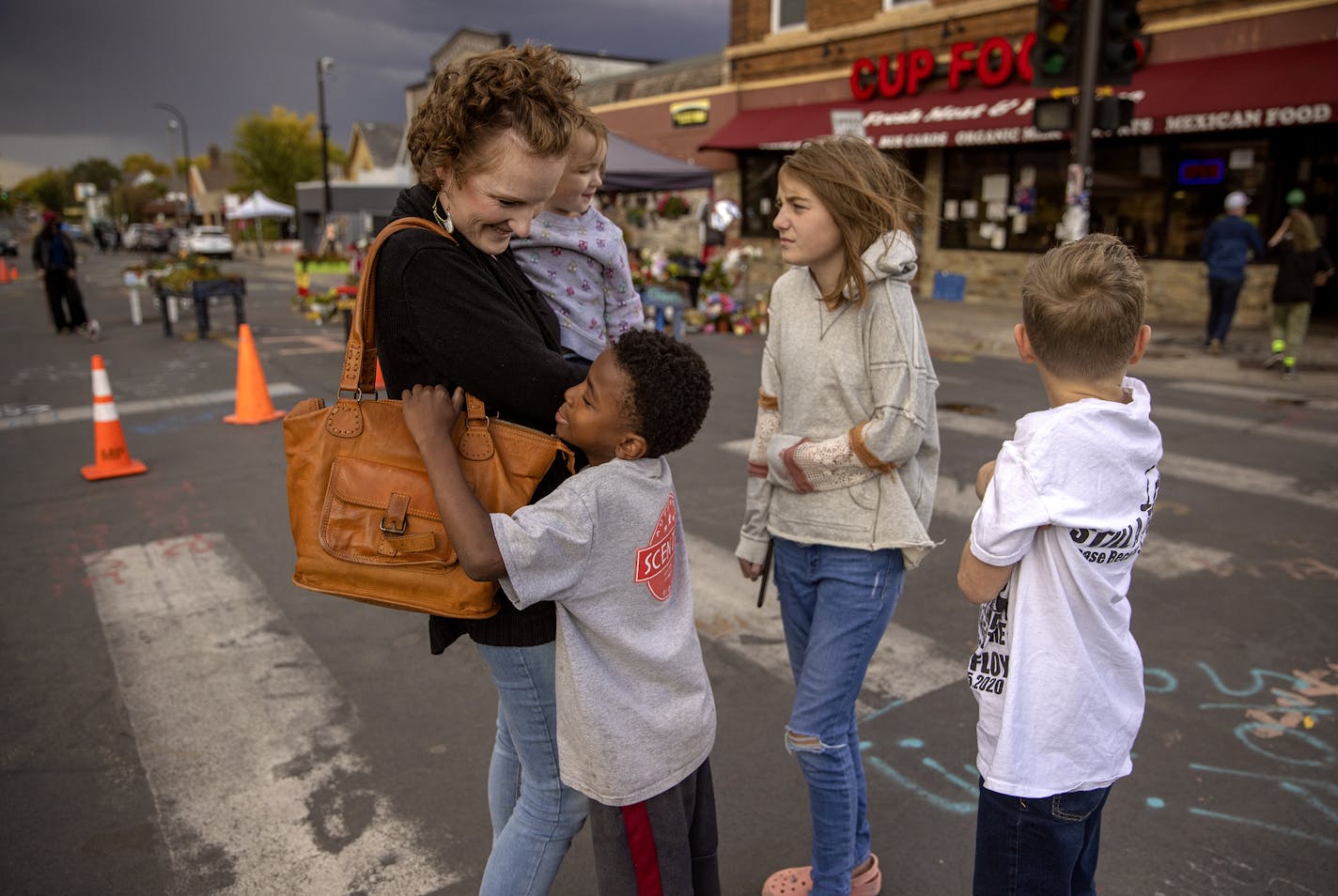 Kate Lundquist returned to the George Floyd memorial last month with children Verabeth, 2, in her arms; Maki, 8, left; Charlotte, 11; and Ridge, 9. A summer visit had convinced the family that they would be more at home in a diverse community in the Twin Cities than in rural Roseau, Minn.