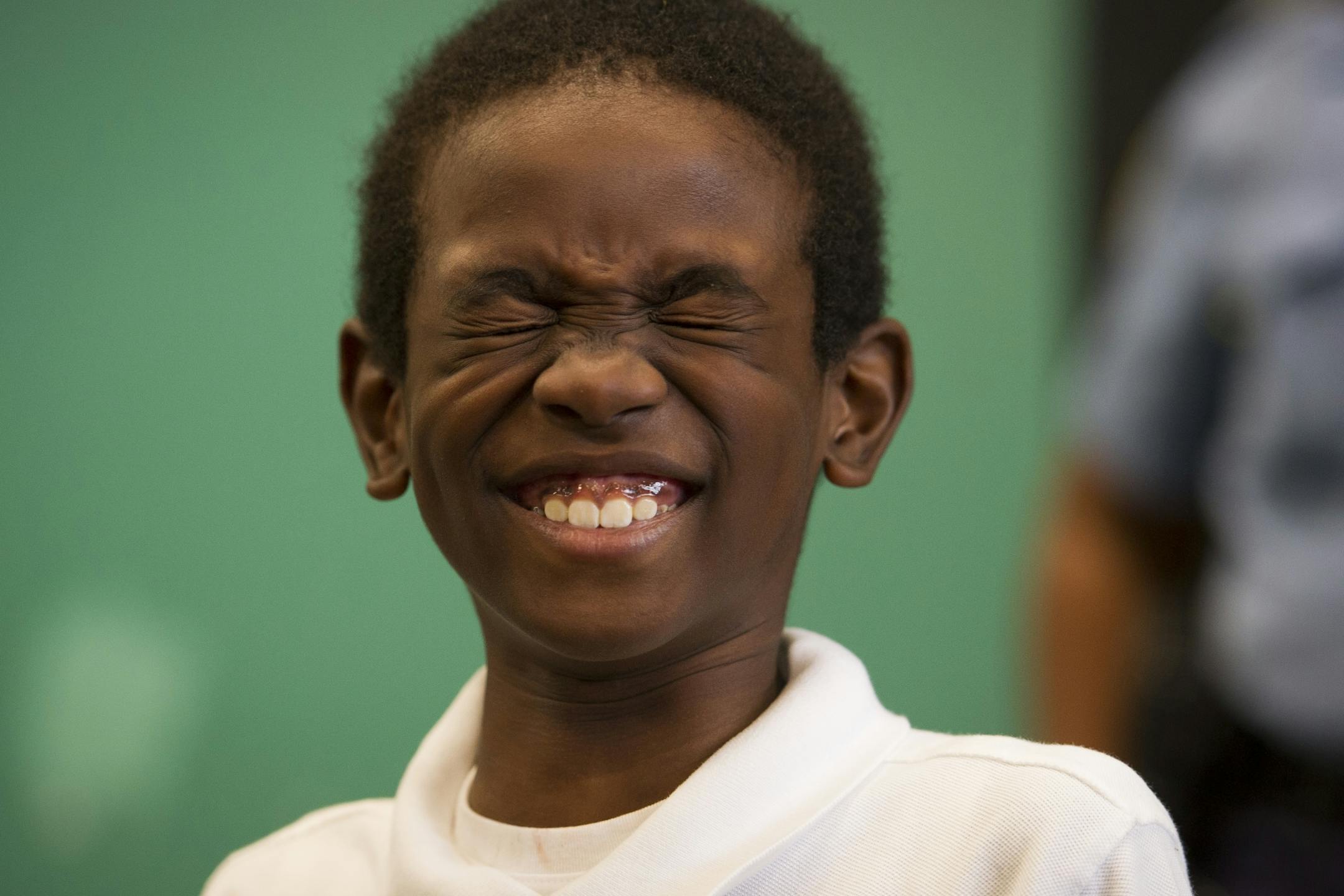 Second grade student Nobel Daniel reacts to having a new pair of Nike shoes put on his feet by a member of the WNBA Champions Minnesota Lynx at Payne Elementary School in Washington, Wednesday, June 6, 2018. Payne Elementary has the highest homeless student population in the district.