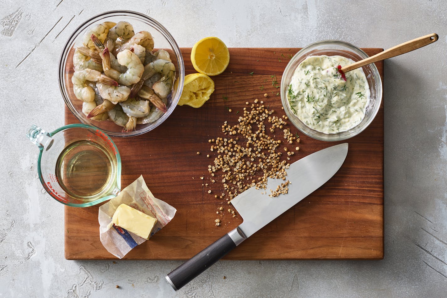 Ingredients for butter-poached shrimp with dill mayonnaise in New York, March 8, 2023. Nix the garlic for coriander seeds and a dollop of dill-speckled mayo for a subtle, speedy dish that's all about the shrimp. Food styled by Barrett Washburne. (James Ransom/The New York Times)