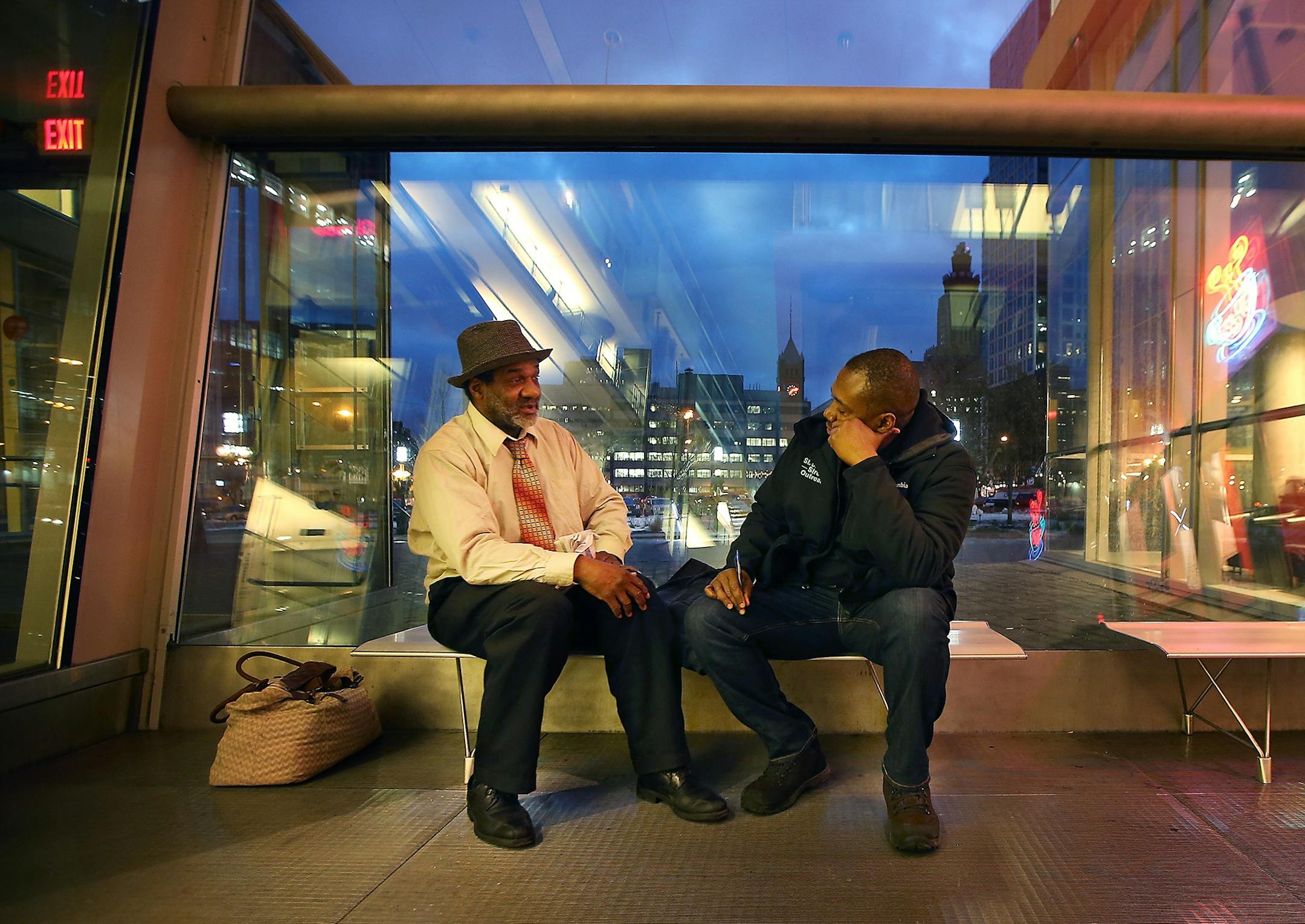 David Jeffries, the Director of Single Adult Programs for St. Stephen's Human Services, listened to Roland Arnold as he spent the morning reading his devotional book at the Hennepin County Library, Thursday, January 28, 2015 in Minneapolis, MN. Many of the homeless sit in the library for the day. The St. Stephen Outreach program participated in an annual count as they scoured the city to count unsheltered homeless people.
