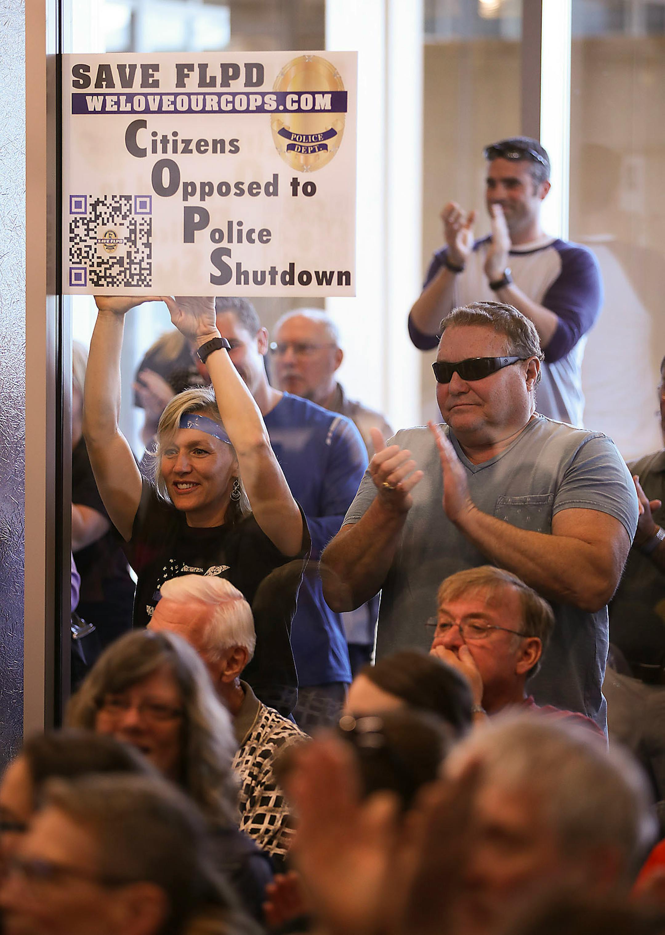 The overflow audience applauded as the Forest Lake City Council voted to reverse their decision to disband the police department at their meeting Monday evening.