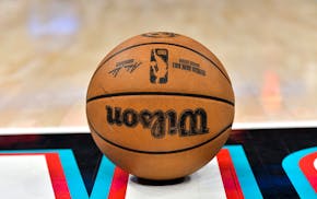 A game ball rests on the court during an NBA contest.