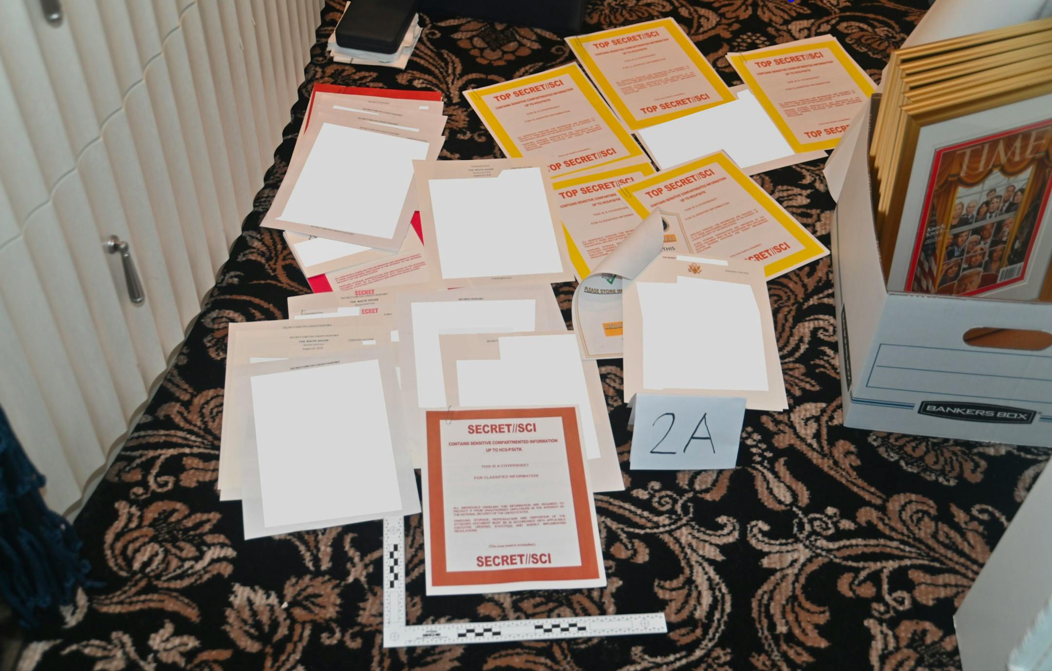 An image the Department of Justice included in an August 30, 2022 court filing shows documents marked SECRET//SCI that were recovered from Donald TrumpÕs Mar-a-Lago club and home in Florida. A long-serving aide to Trump was captured on security camera footage moving boxes out of a storage room at Mar-a-Lago both before and after the Justice Department issued a subpoena in May demanding the return of all classified documents, according to three people familiar with the matter.. (Department of Justice via The New York Times) Ñ NO SALES. EDITORIAL USE ONLY Ñ