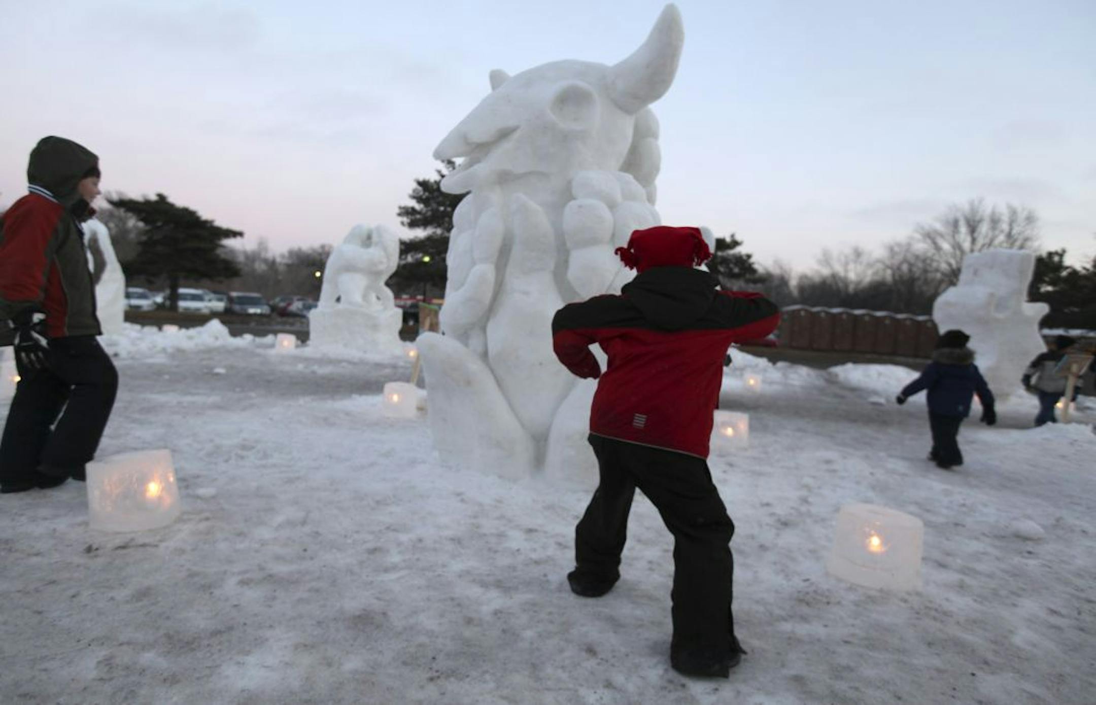 William Pryce, 6, middle, of Minneapolis, ran passed a sculpture made by Minnesota Big Snow team as he was chasing his brother Andrew during the Loppet event at Theodore Wirth Park in Minneapolis Min., Saturday, February 4, 2012.