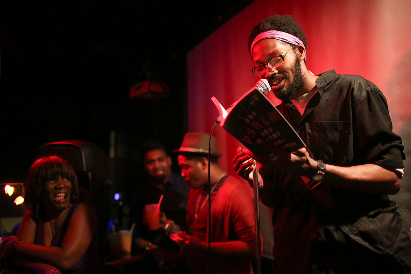 Khary Jackson read from his work during The Prince Purple Poetry Party Wednesday night at First Ave. ] JEFF WHEELER • jeff.wheeler@startribune.com One of the off-site events at the start of the AWP Conference & Bookfair was The Prince Purple Poetry Party Wednesday night, April 8, 2015 in The Record Room at First Ave. in Minneapolis. More than a dozen poets read poems they wrote that were inspired by the music of Prince.