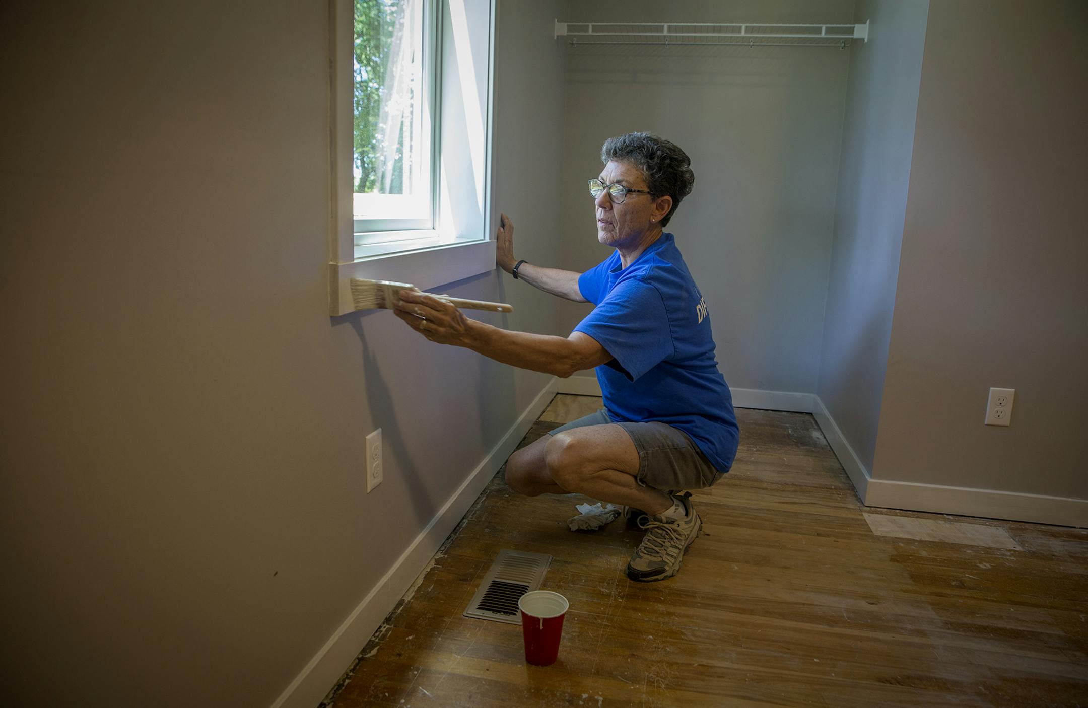 Sharon Pfeiffer of Woodbury painted a bedroom of a six-bedroom farmhouse that is being renovated for homeless families in Washington County.