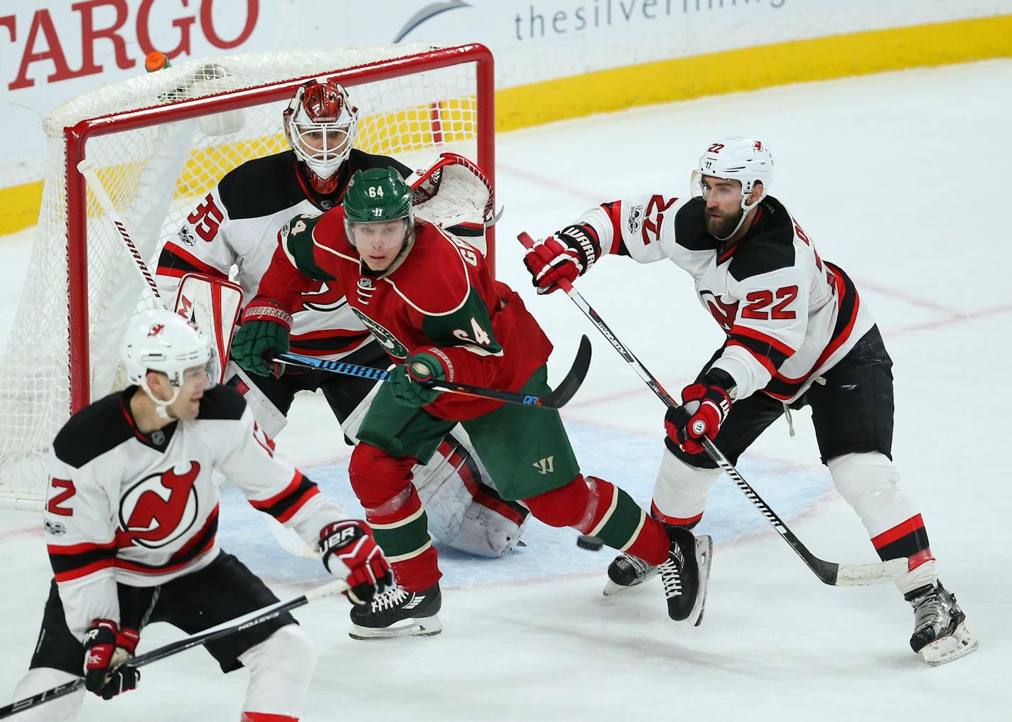 Minnesota Wild center Mikael Granlund (64) is shoved by New Jersey Devils defenseman Kyle Quincey (22) as he screens goalie Cory Schneider just as an incoming shot approached in the third period Tuesday, Jan. 17, 2017 at Xcel Energy Center in St. Paul, Minn. The Devils won 4-3. (Jeff Wheeler/Minneapolis Star Tribune/TNS) ORG XMIT: 1196200