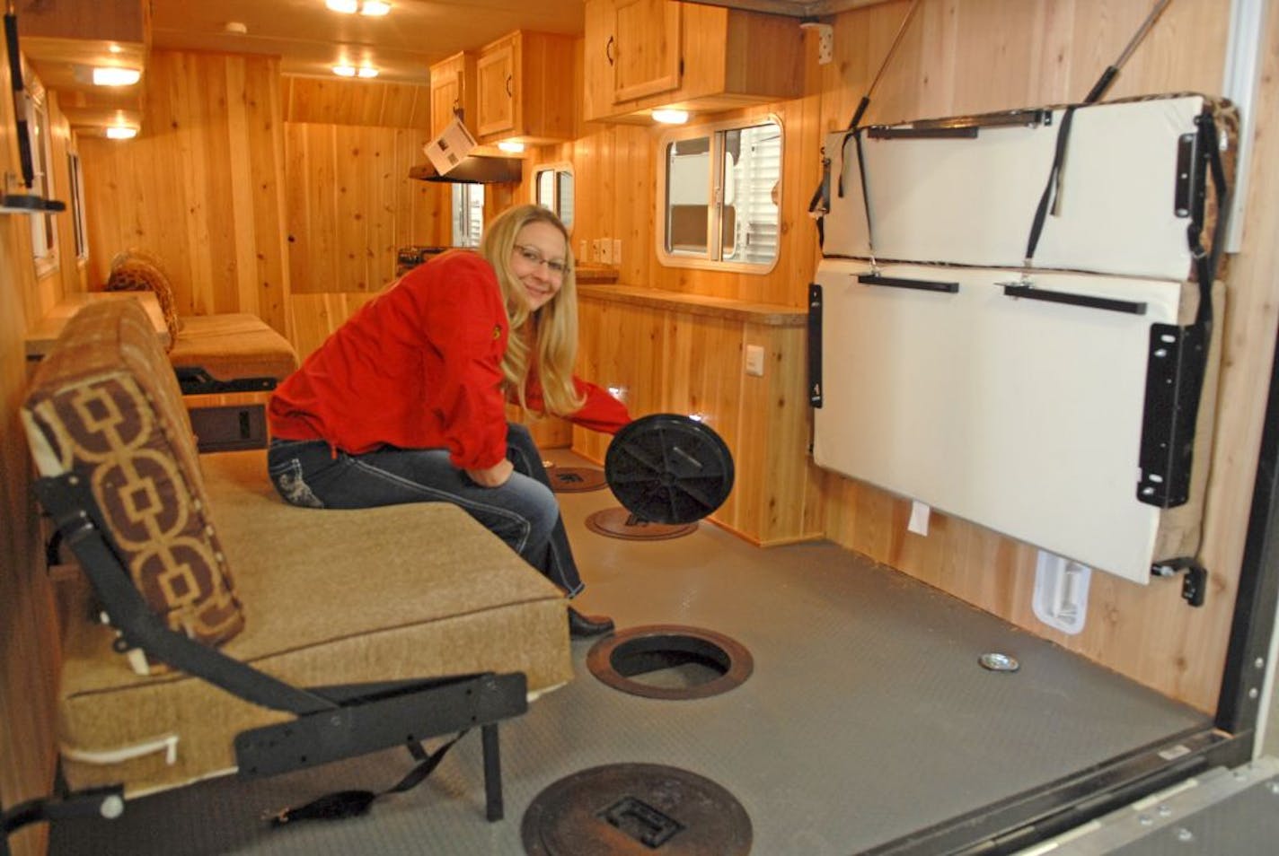 Sarah Coates Lange, general manager of Coates RV Center in Forest Lake, inside a Salem Ice Cabin, which is on display at the St. Paul Ice Fishing and Winter Sports Show, which ends today at RiverCentre in St. Paul. The pull-behind travel trailer doubles as a mobile ice fishing house.