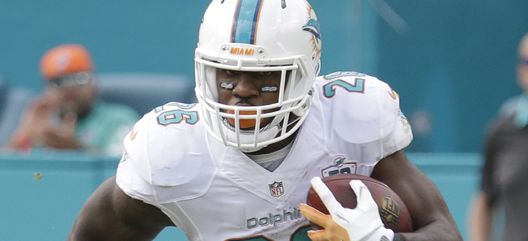 Miami Dolphins running back Lamar Miller (26) carries the ball during the first half of an NFL football game against the Baltimore Ravens, Sunday, Dec. 6, 2015, in Miami Gardens, Fla. (AP Photo/Lynne Sladky)