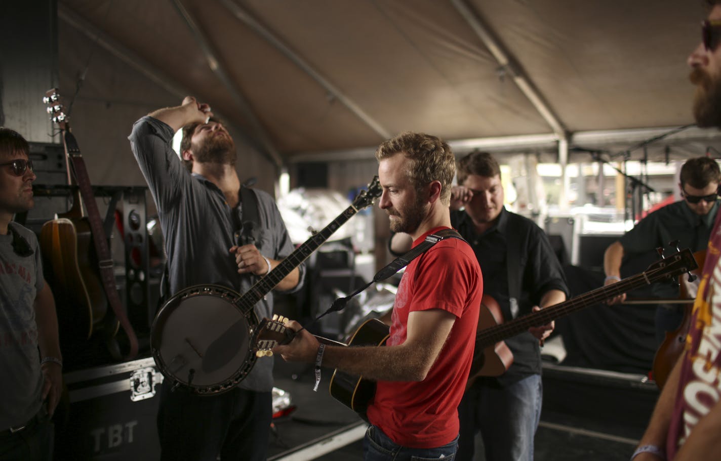 Dave Carroll put drops in his eyes moments before he and bandmates Dave Simonett, Tim Saxhaug, and Eamonn McLain, from left, stepped on stage to play to a crowd of more than 20,000 at the Forecastle Festival in Louisville, KY. At far left was string tech Dave Feirn while tour manager Mike Tholen was at extreme right. ] JEFF WHEELER &#x201a;&#xc4;&#xa2; jeff.wheeler@startribune.com Trampled By Turtles performed at the Forecastle Festival in Louisville, Kentucky on Sunday, July 20, 2014.