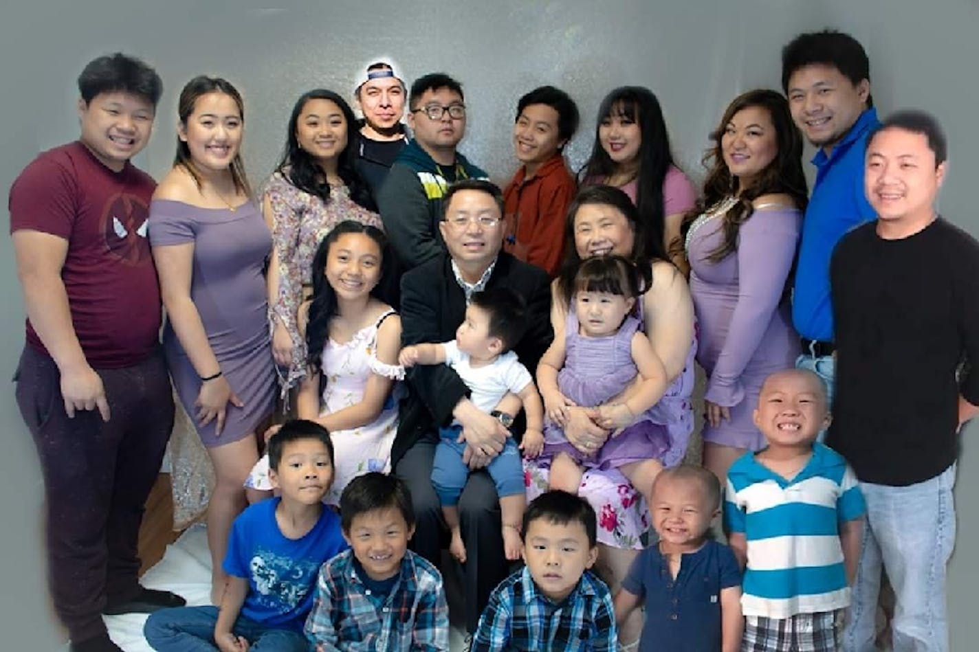 Chiasher Fong Vue, center, surrounded by his family.