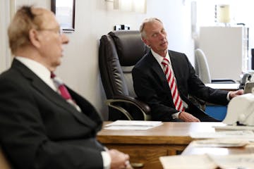 Father and son Al, left, and Jim Kordiak talked together at the tax business they ran together for decades as Al reached for a weathered photo of his 