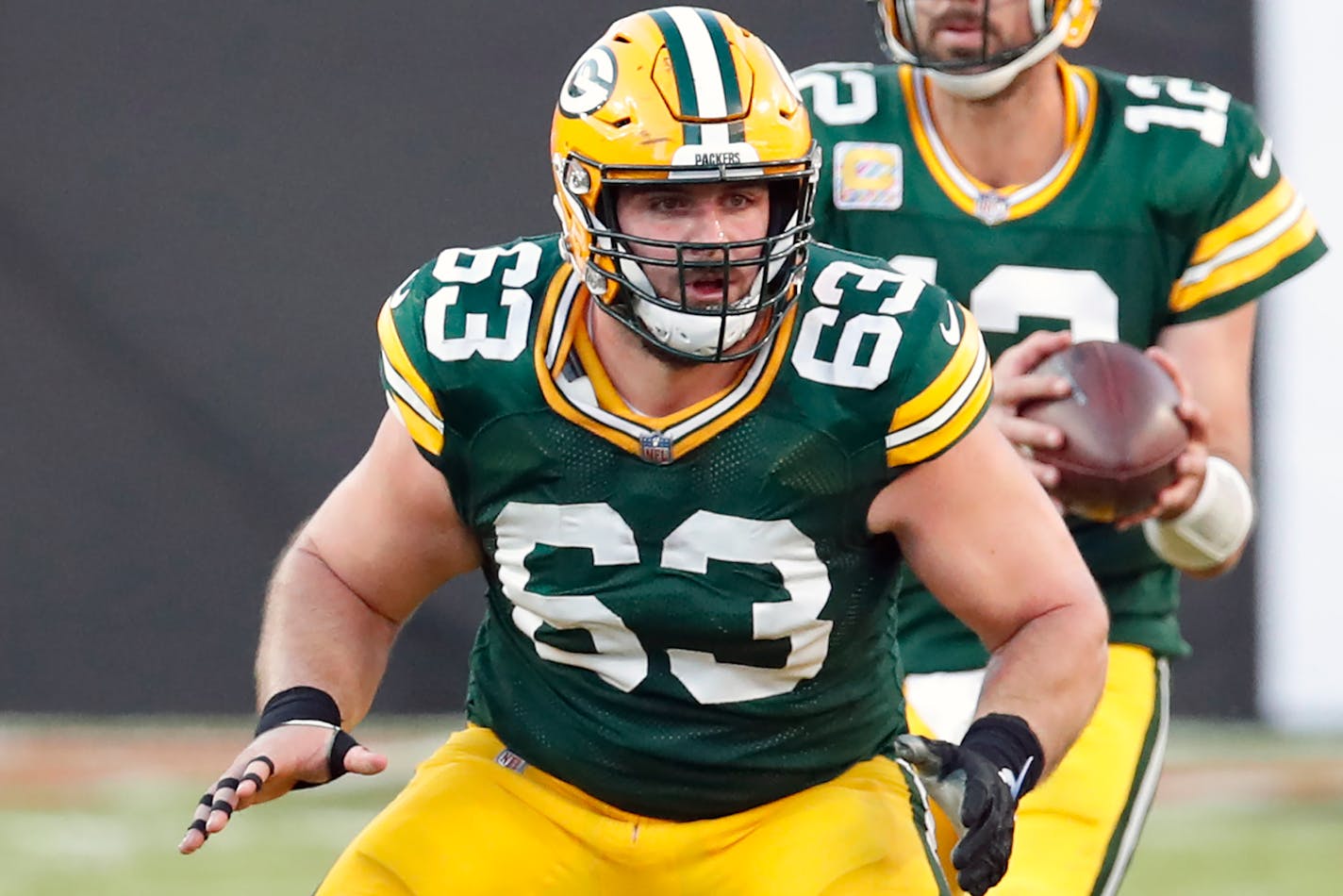 FILE - Green Bay Packers center Corey Linsley (63) blocks for quarterback Aaron Rodgers during an NFL football game against the Tampa Bay Buccaneers in Tampa, Fla., in this Sunday, Oct. 18, 2020, file photo. Linsley was selected Friday, Jan. 8, 2021, to The Associated Press All-Pro Team. (AP Photo/Jeff Haynes, File)