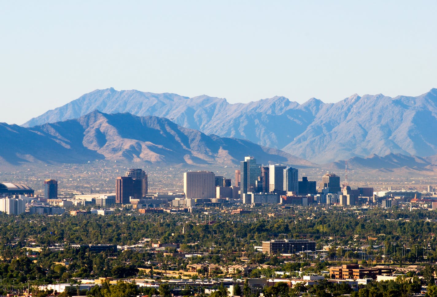 Downtown Phoenix skyline with the South and Sierra Estrella mountain ranges in the background. istock photo