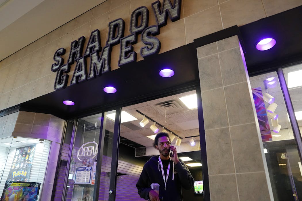 Anthony Abousweid took a call at his Shadow Games store at Maplewood Mall.