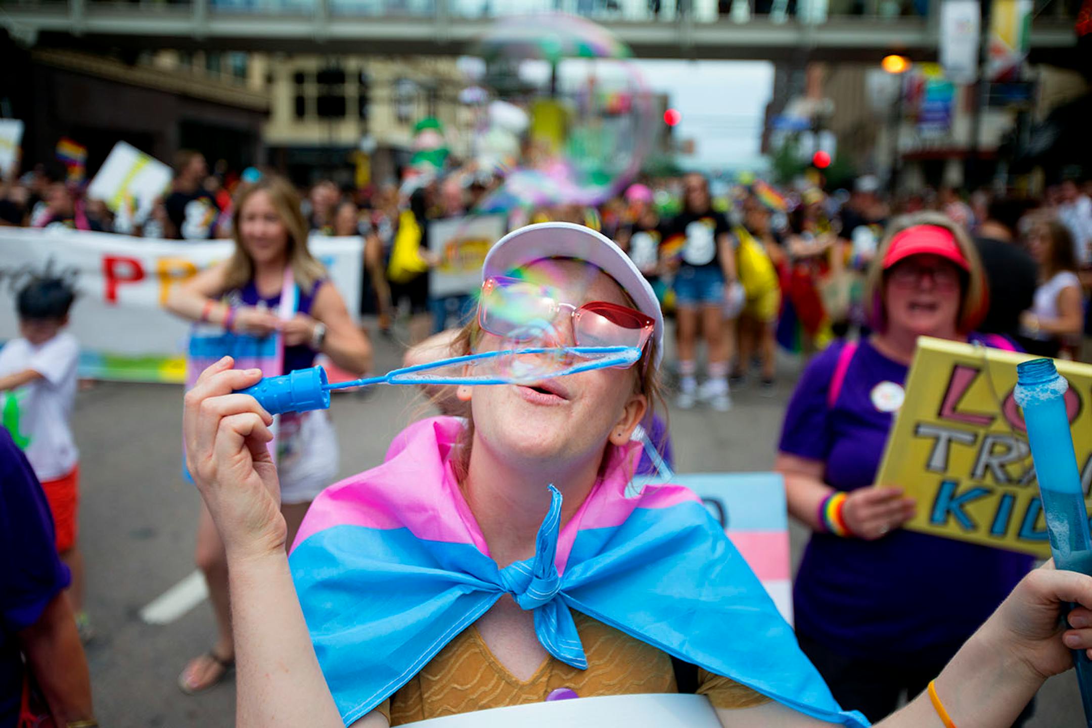Anna Bey blows bubbles as they march down Hennepin on Sunday.