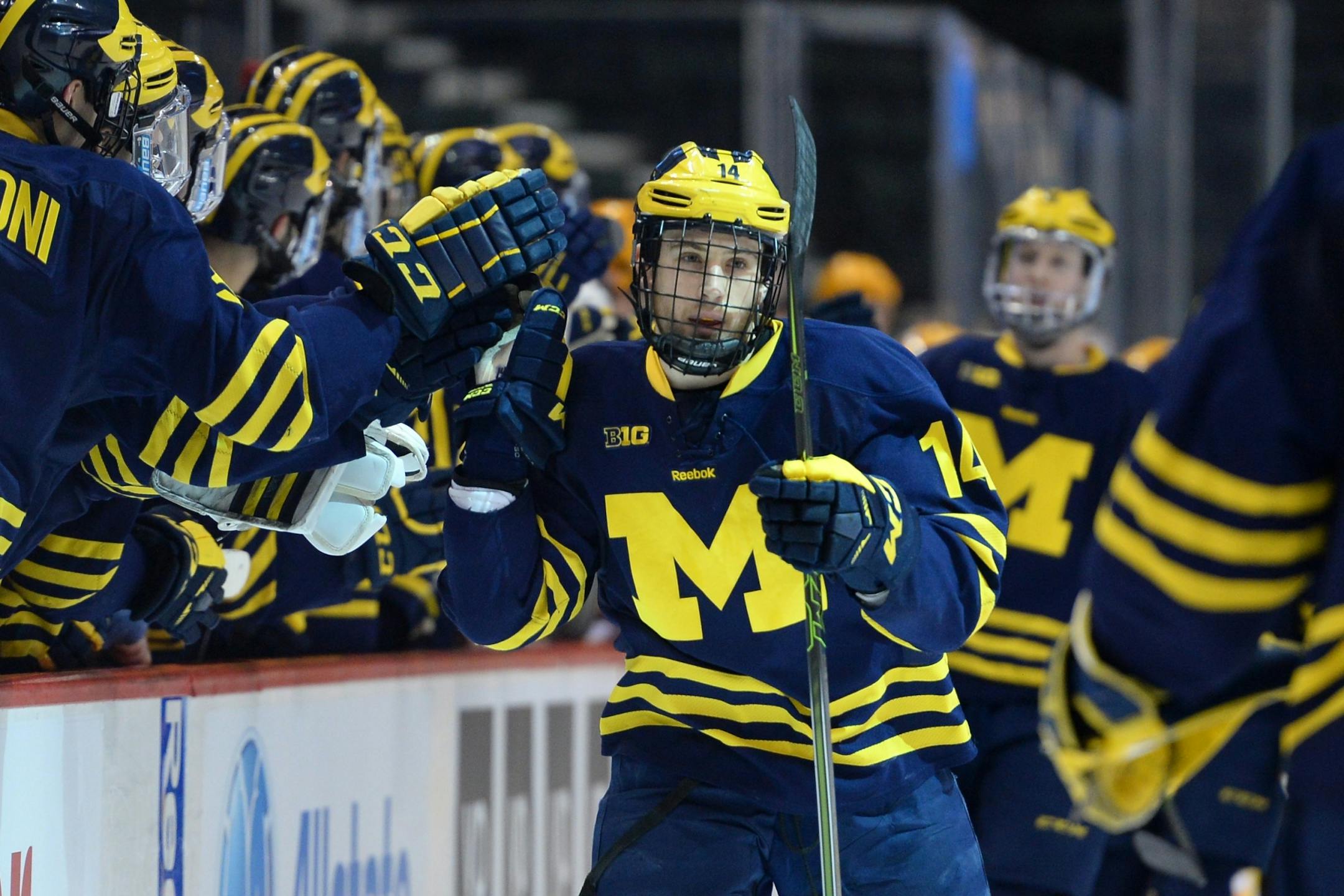 Michigan Wolverines forward Tyler Motte (14) high fived teammates after scoring a goal against Minnesota during a first period power play.