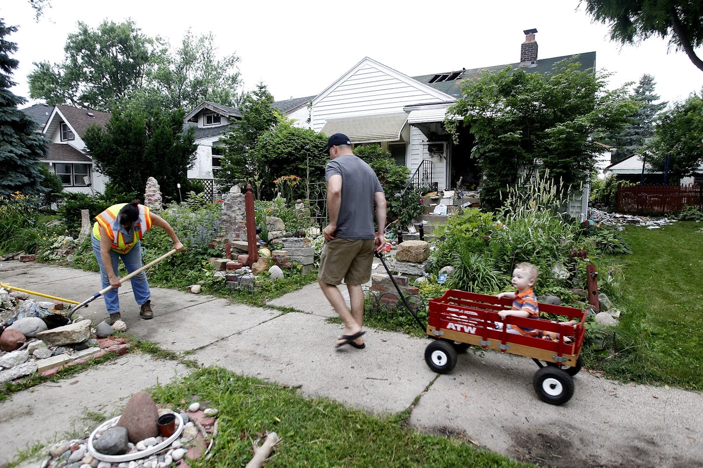 A city worker cleaned up at the scene of a fatal fire on Hamline Avenue North in St. Paul on Tuesday.