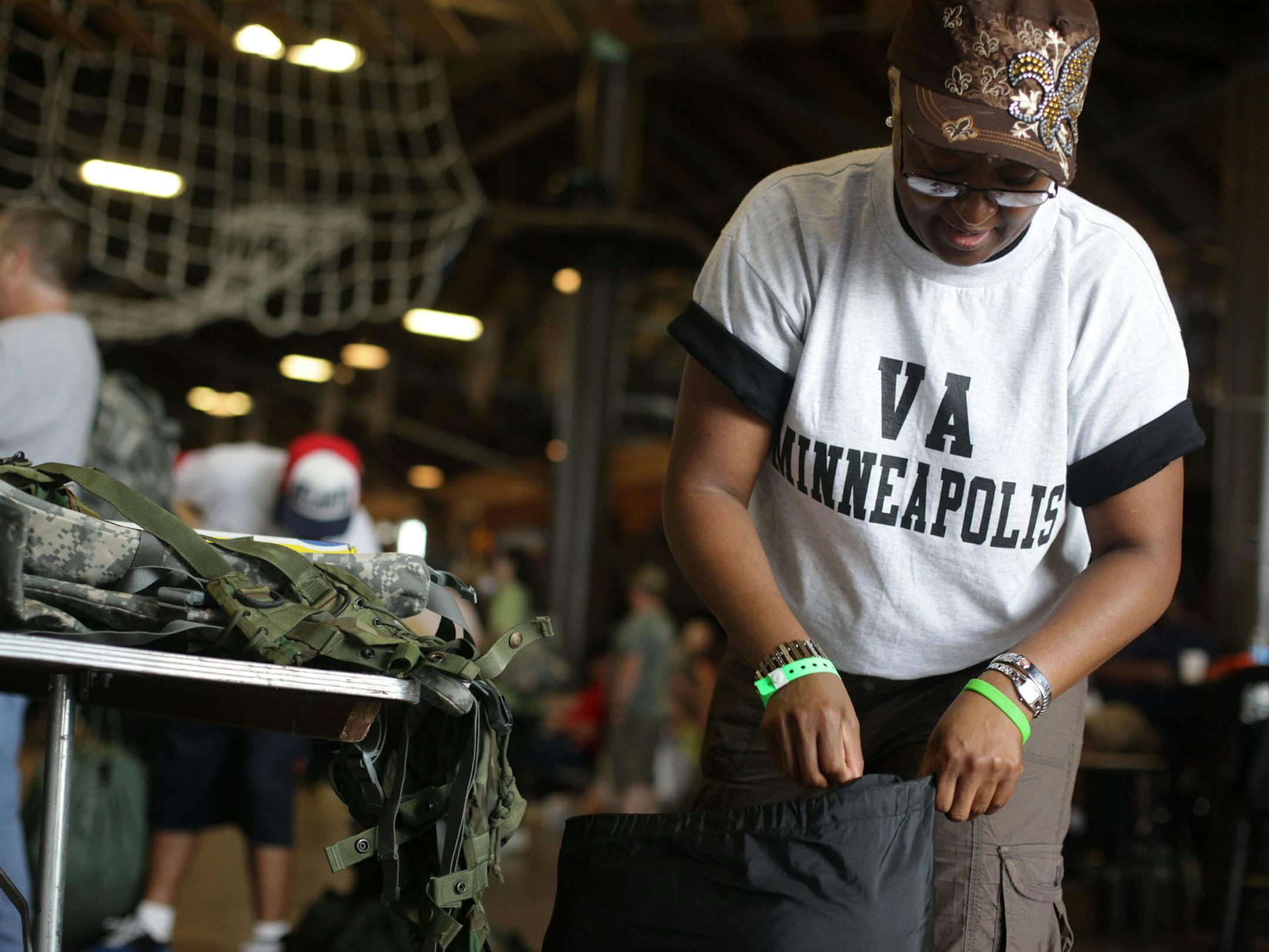 Carla Julien, originally of South Louisiana, more recently the Twin Cities, packs all of her military surplus supplies into a duffle bag at the StandDown on Tuesday afternoon. Julien served in the Air Force during Desert Storm, from 1988 through 1992.] The first of the two day Metro StandDown, hosted by the Minnesota Assistance Council for Veterans, was held Tuesday at the Boy Scout Basecamp in Fort Snelling. The event brought a variety of services and agencies to the veterans, including free su
