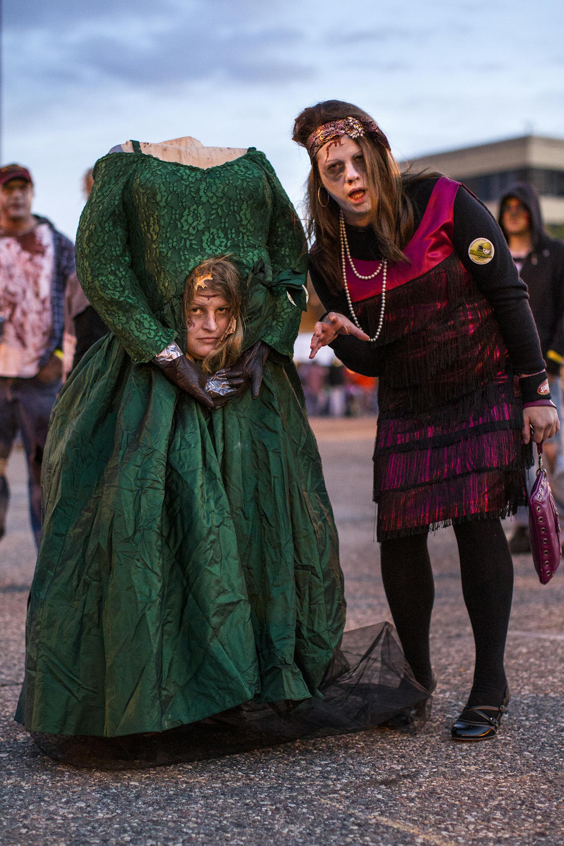 Headless bridesmaid Jodi Gerner, 27, of Mora and Karon Heruth, 28, of Braham attend the Zombie Pub Crawl in downtown Minneapolis October 12, 2013. The event featured live music, a ferris wheel and food trucks stationed in two parking lots but encouraged zombies to roam the many participating local bars. (Courtney Perry/Special to the Star Tribune)