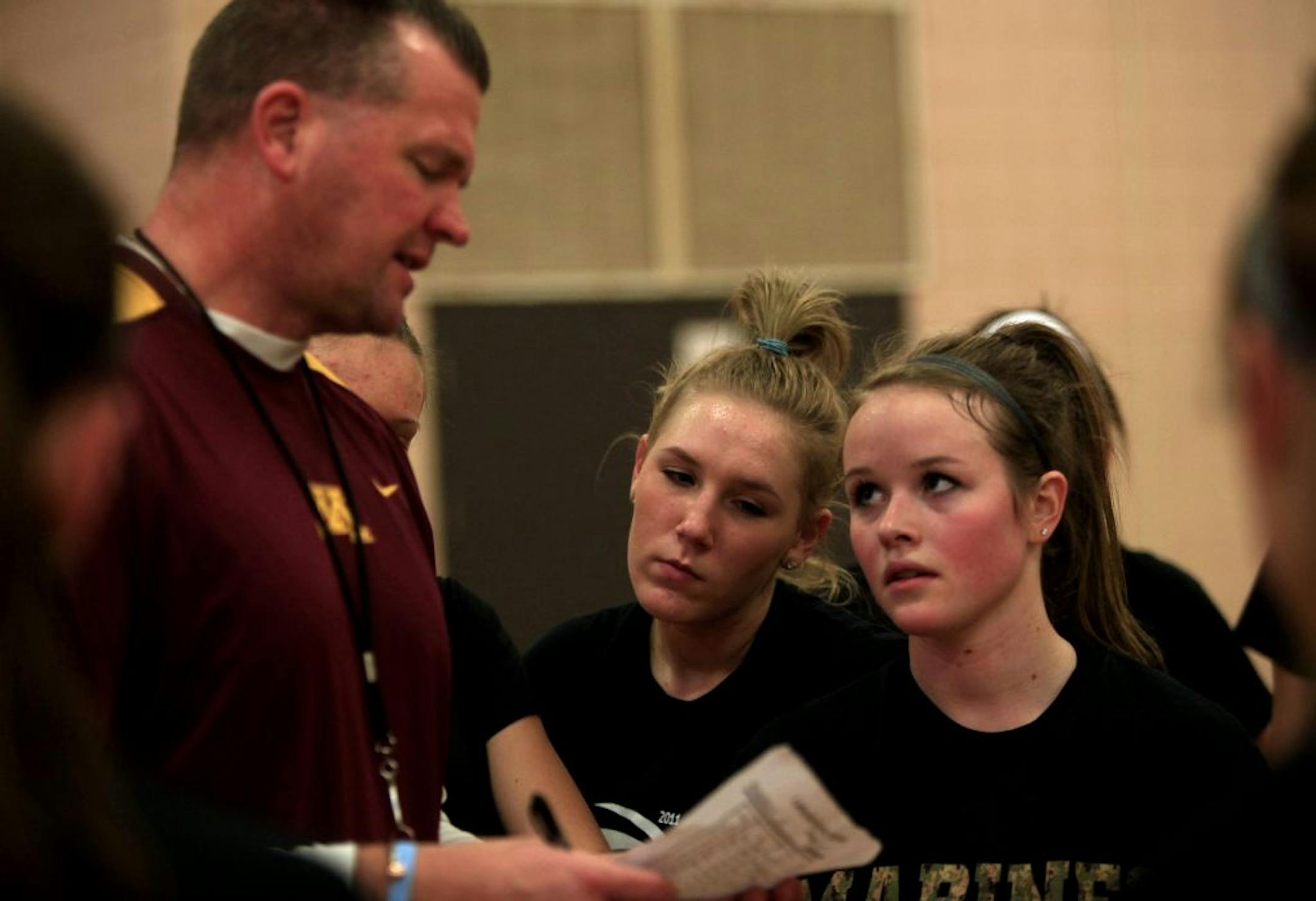 Lakeville North coach Andy Berkvam gave instructions as his daughter Cassie, right, and teammate Taylor Stewart, center, listened during a practice in the last week of November. Photo by Joel Koyama • jkoyama@startribune.com
