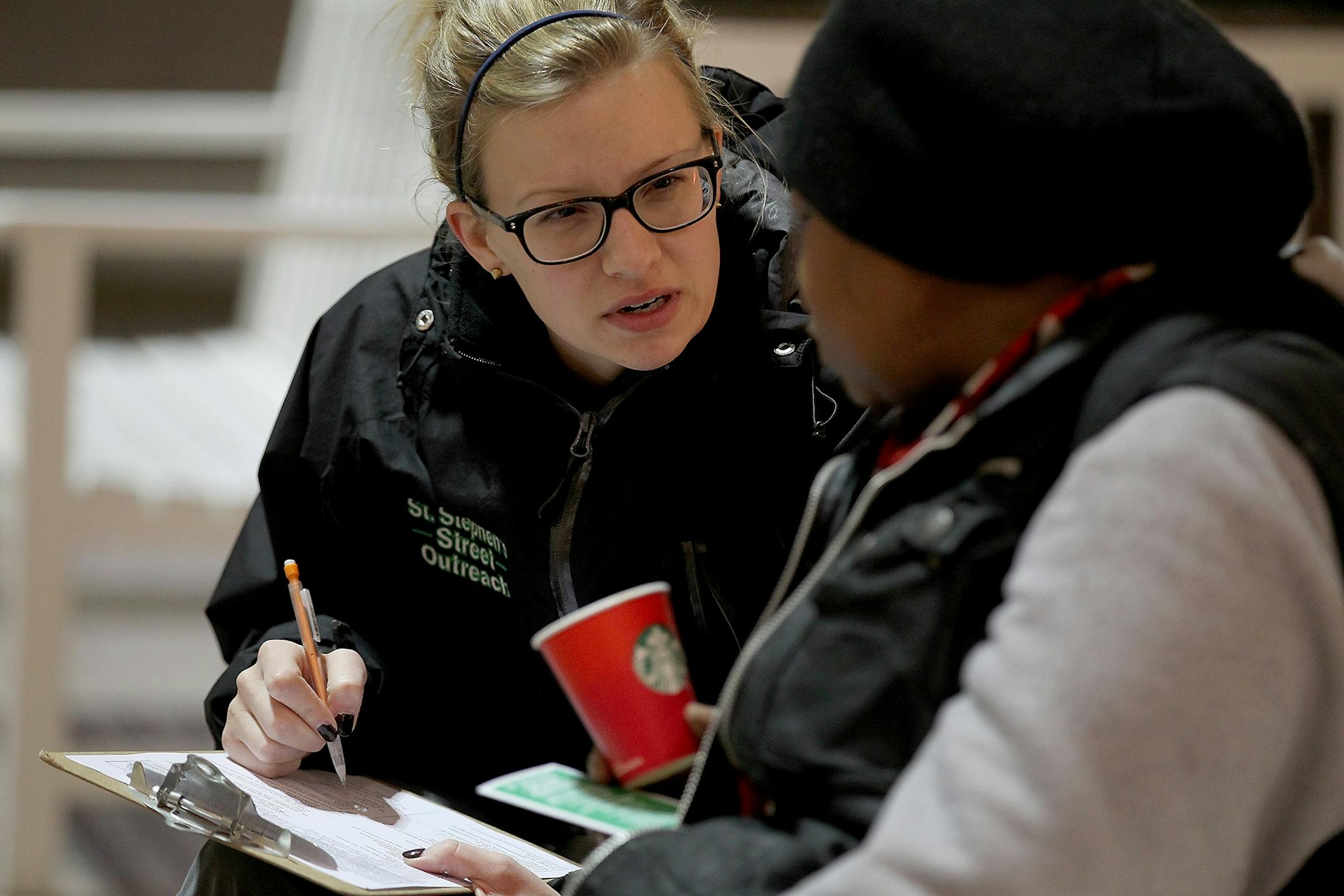 Breanna Schell, MSW, LGSW, and the Street Outreach Program Manager for St. Stephen's Human Services, listened to Donna as she sat in the lobby of the IDS building after spending the night on the rail system early Thursday, January 28, 2015 in Minneapolis, MN. Many of the homeless sit in places like the IDS building, the library, and the train station for the day. The St. Stephen Outreach program participated in an annual count as they scoured the city to count unsheltered homeless people.