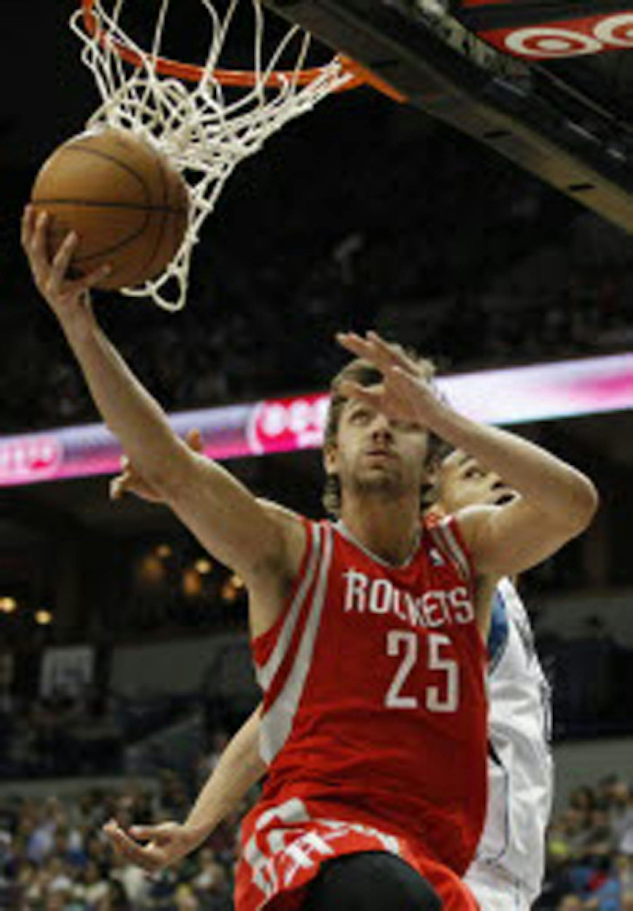Rockets forward Chandler Parsons (25) drove to the basket past new Timberwolves center Chris Johnson in the second half of Minnesota's 92-79 victory Saturday.