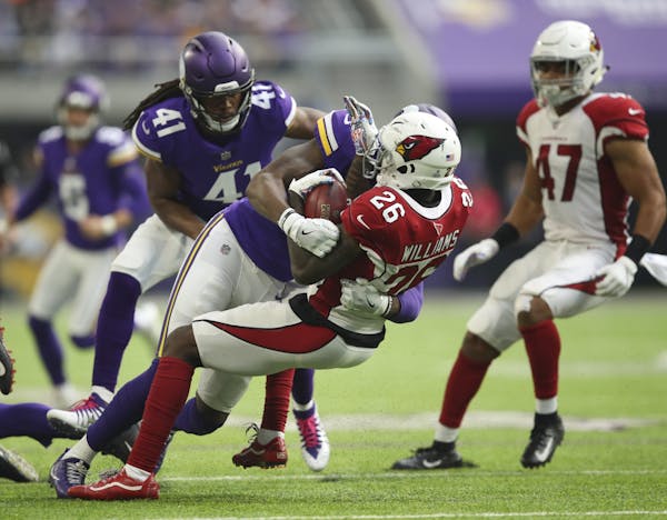 Brandon Williams (26) was stopped by Vikings defensive back George Iloka (23).