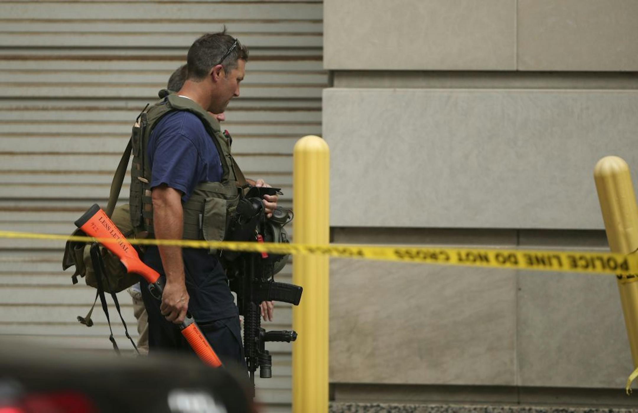 A SWAT team member went back into the Hilton after retrieving a specialized "bean bag" shotgun from his vehicle outside at the Minneapolis hotel late Thursday afternoon.
