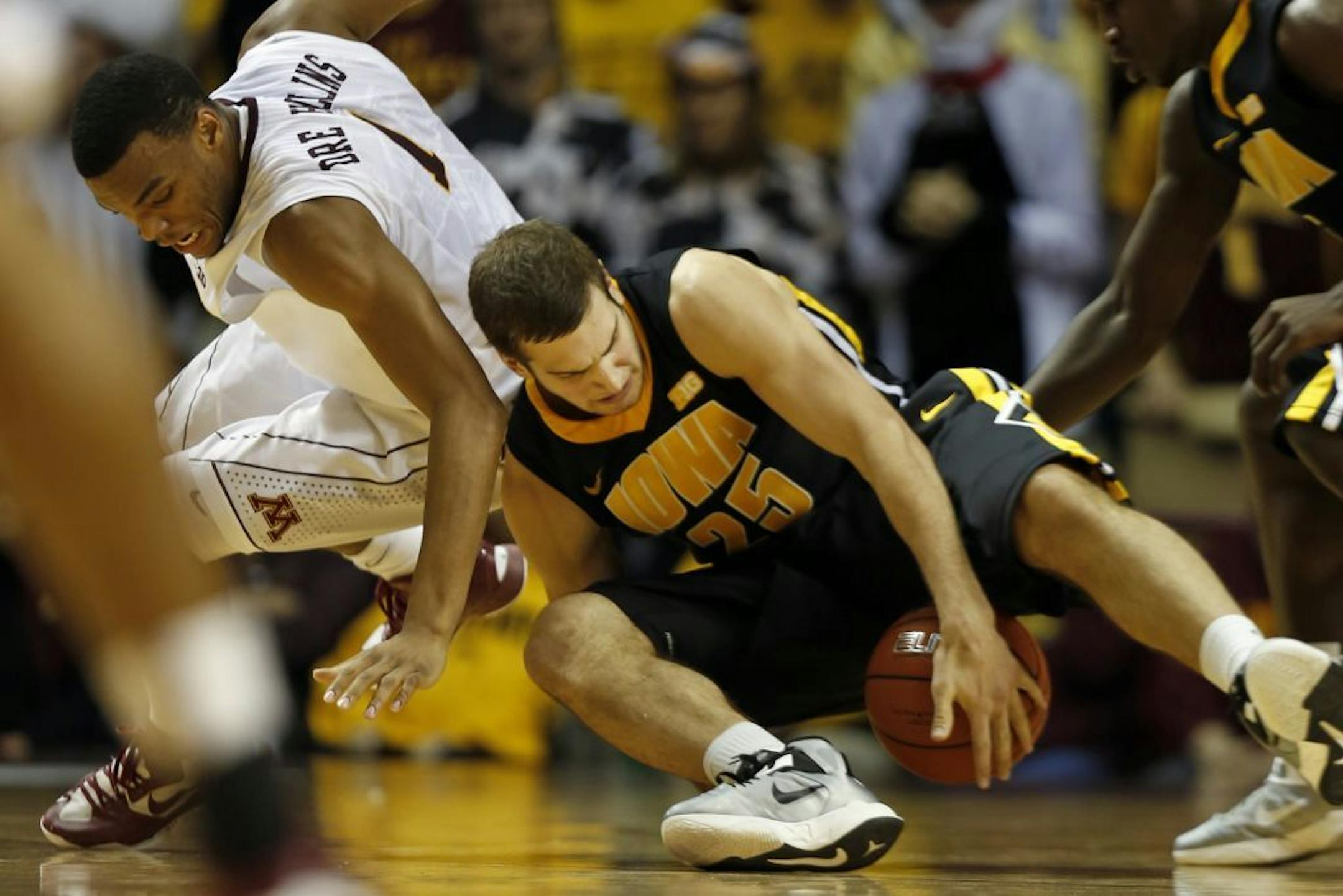 Andre Hollins (1) fights for a loose ball against Eric May (25) of Iowa.