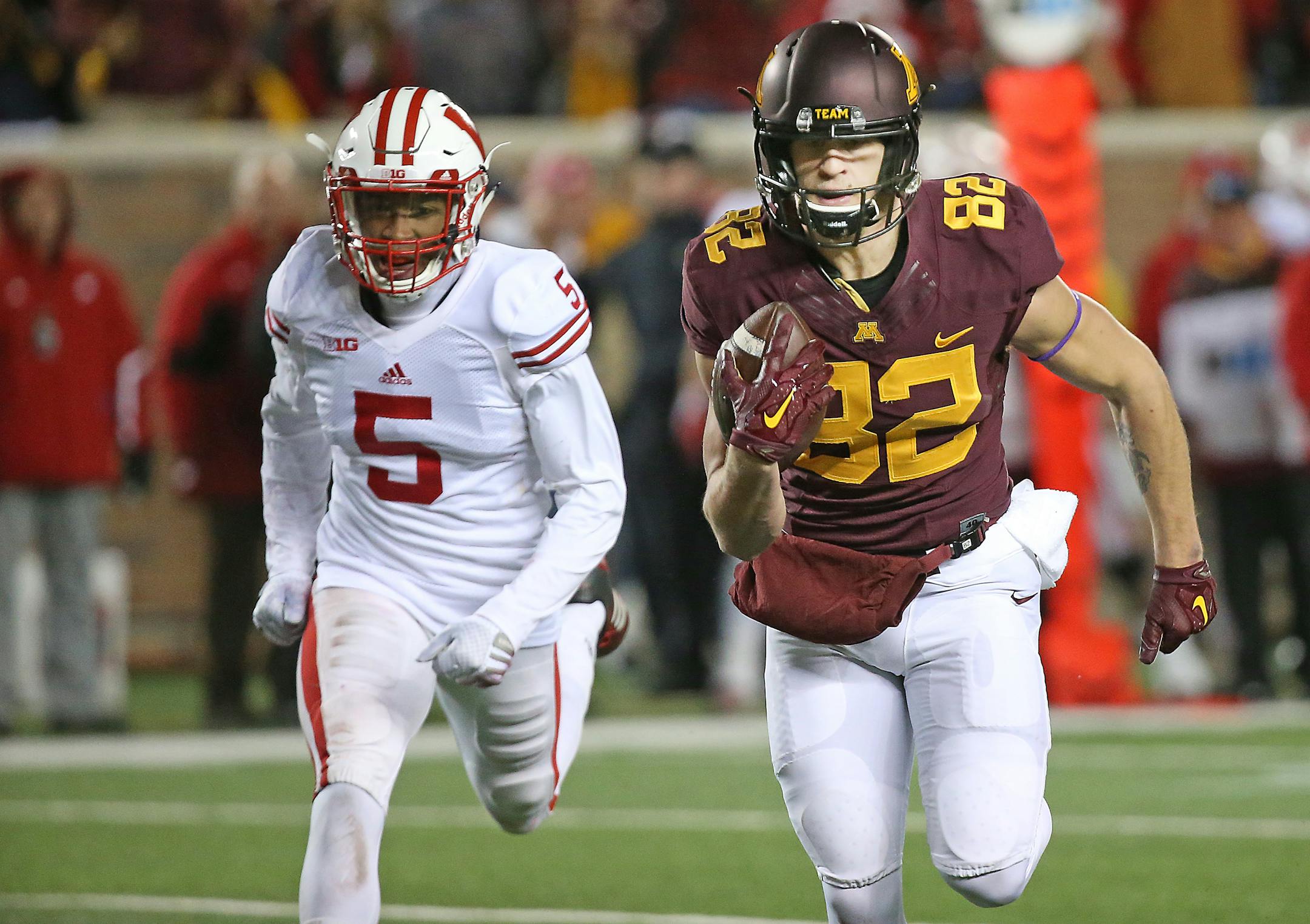 Gophers wide receiver Drew Wolitarsky headed for the end zone for a touchdown as he was being chased by Wisconsin cornerback Darius Hillary in the fourth quarter Saturday.