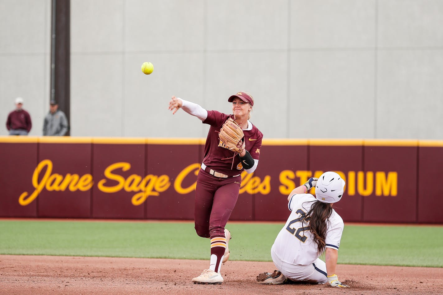 Gophers shortstop Brandt Carlie threw to first as Michigan's Julia Jimenez (22) slid into second base during Game 2 of a doubleheader at Jane Sage Cowles Stadium on Saturday, May 8, 2021. The Wolverines won 3-1, their third victory in a row in the series. (Kelly Hagenson)