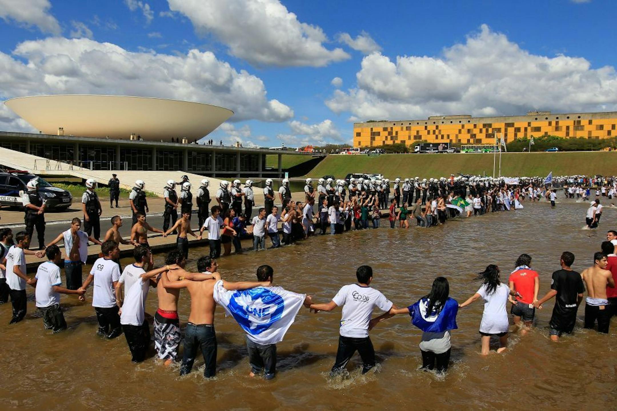 Demonstrators from the national student union gather inside the reflection pool outside Congress to demand 10 percent of the country's GDP be spent on public education in Brasilia, Brazil, Thursday, June 27, 2013.
