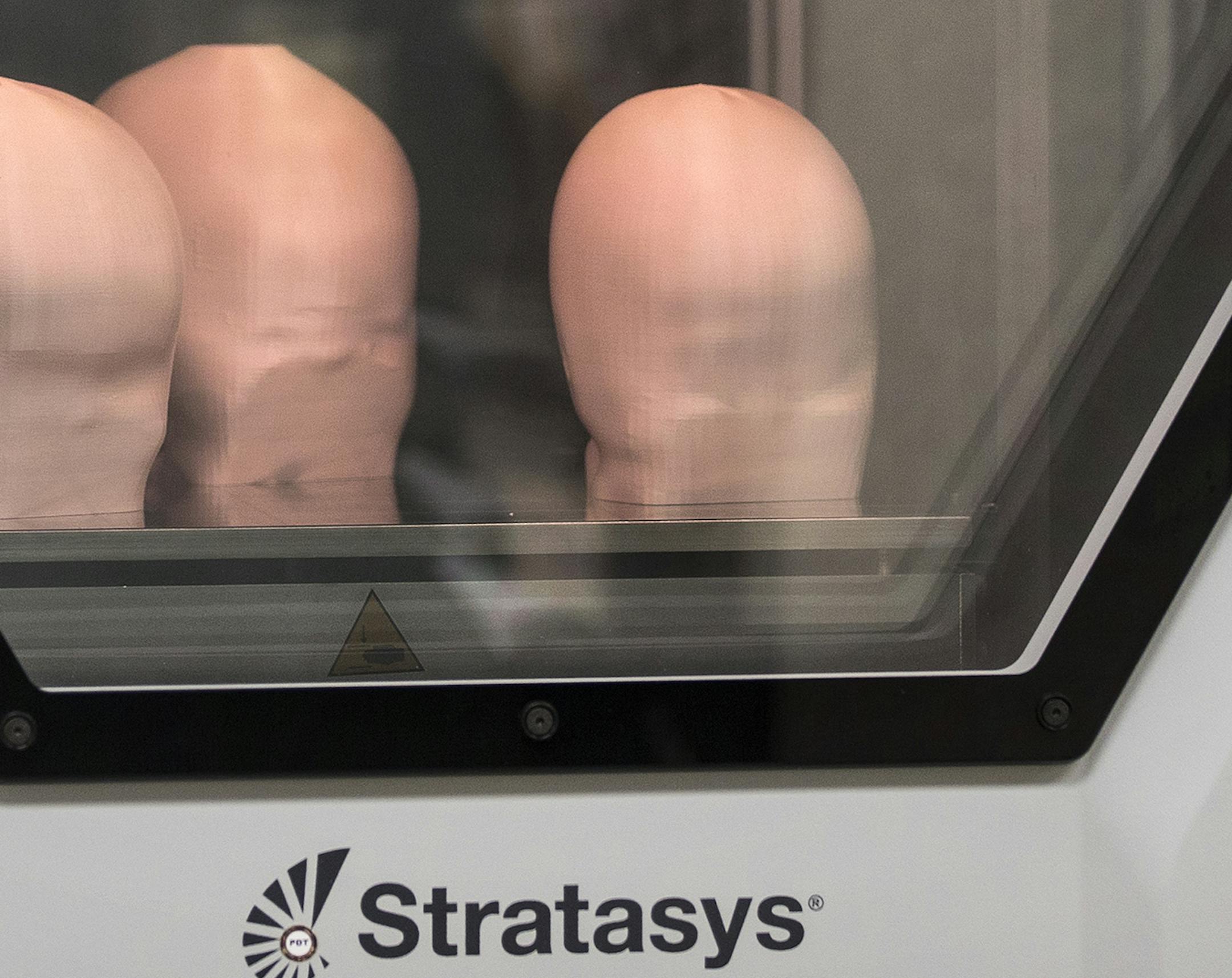 Head models of babies are 3D printed by a Stratasys 3D printer at Gillette Children's Specialty Healthcare's Assistive Technology lab in St. Paul on Monday, July 13, 2015. The models will then be used to make helmets for the babies to treat their flat head syndrome. ] LEILA NAVIDI leila.navidi@startribune.com / BACKGROUND INFORMATION: Gillette Children's Speciality Healthcare is now using a Stratasys 3D printer to make molds for skull helmets to treat babies suffering from flat head syndrome.