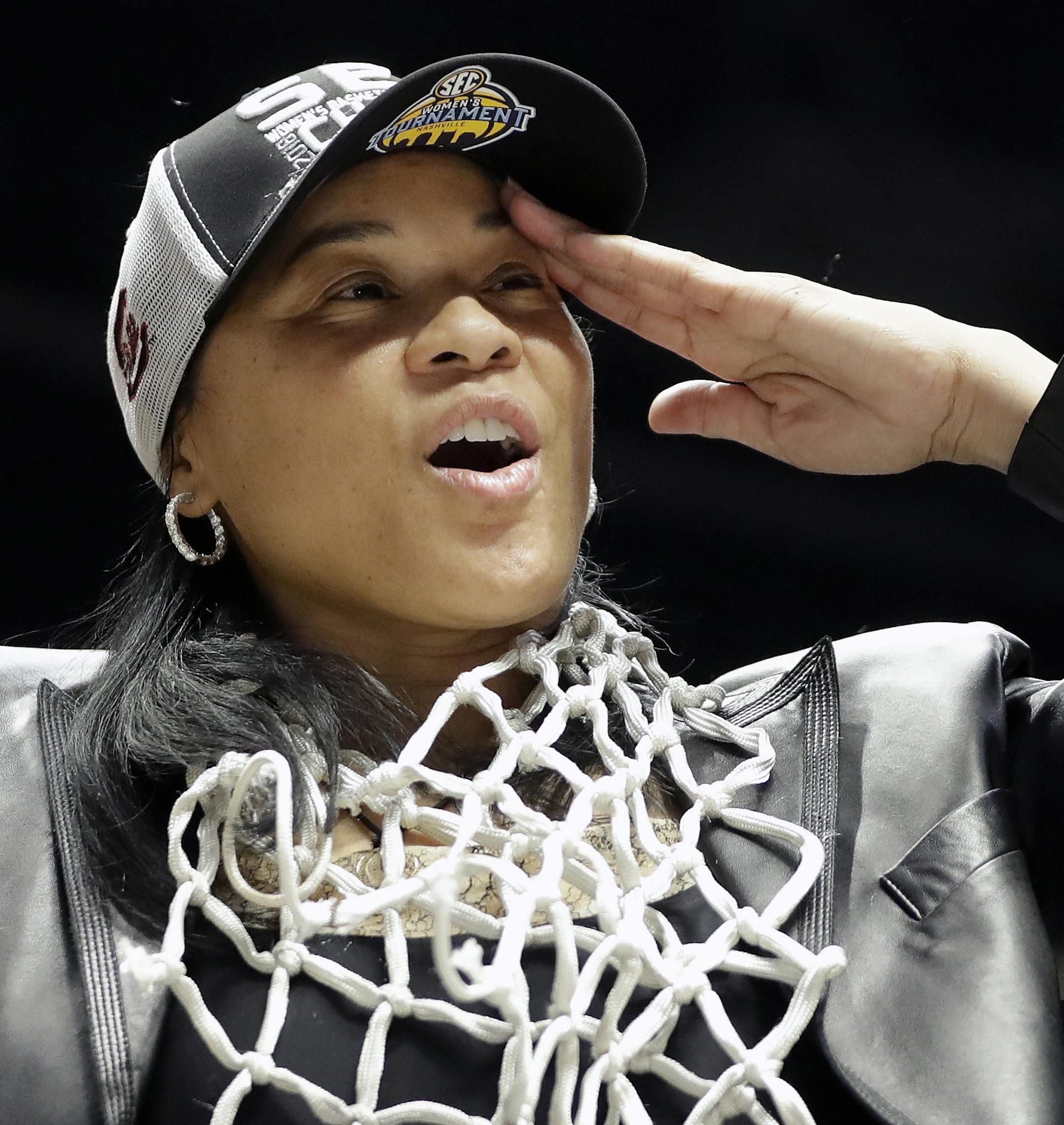 South Carolina head coach Dawn Staley salutes the fans after she cut down the net following her team's win over Mississippi State in an NCAA college basketball championship game at the women's Southeastern Conference tournament Sunday, March 4, 2018, in Nashville, Tenn. (AP Photo/Mark Humphrey)