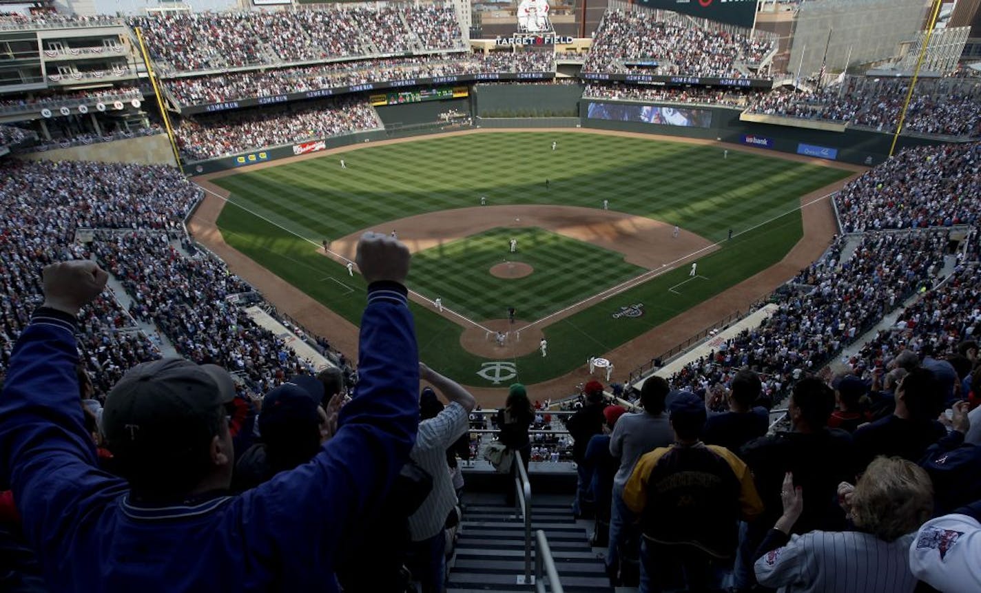 Fans cheered as Jason Kubel headed for home after hitting the first homerun at Target Field.