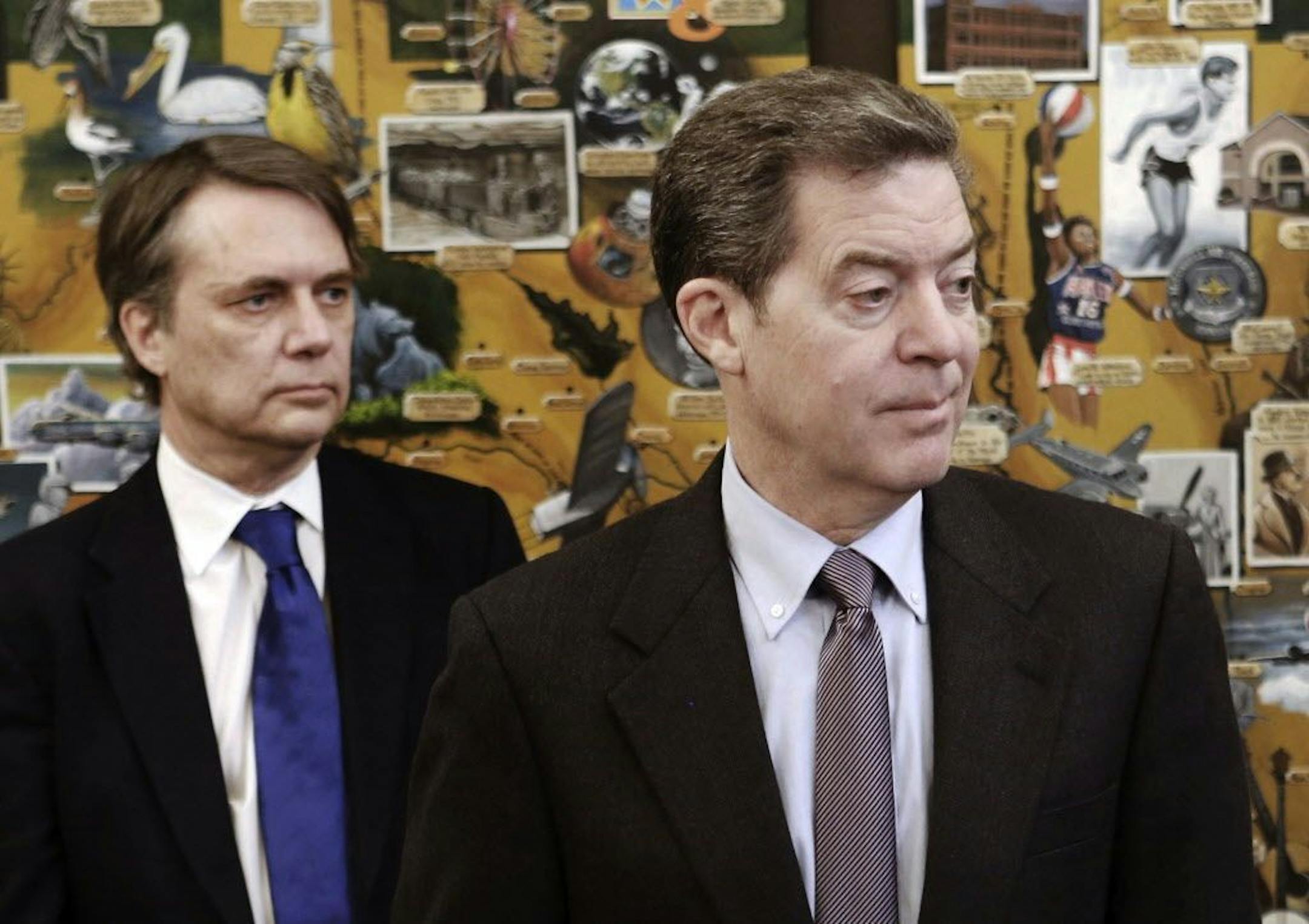 FILE - In this March 9, 2017 file photo, Kansas Gov. Sam Brownback, right, along with Lt. Gov. Jeff Colyer participates in a humanitarian award ceremony at the statehouse in Topeka, Kans. Brownback remains the governor of Kansas while he awaits U.S. Senate confirmation to take an ambassador post in the administration of President Donald Trump. But he has allowed Colyer to make major decisions for the administration, leading to an awkward situation in running the state.