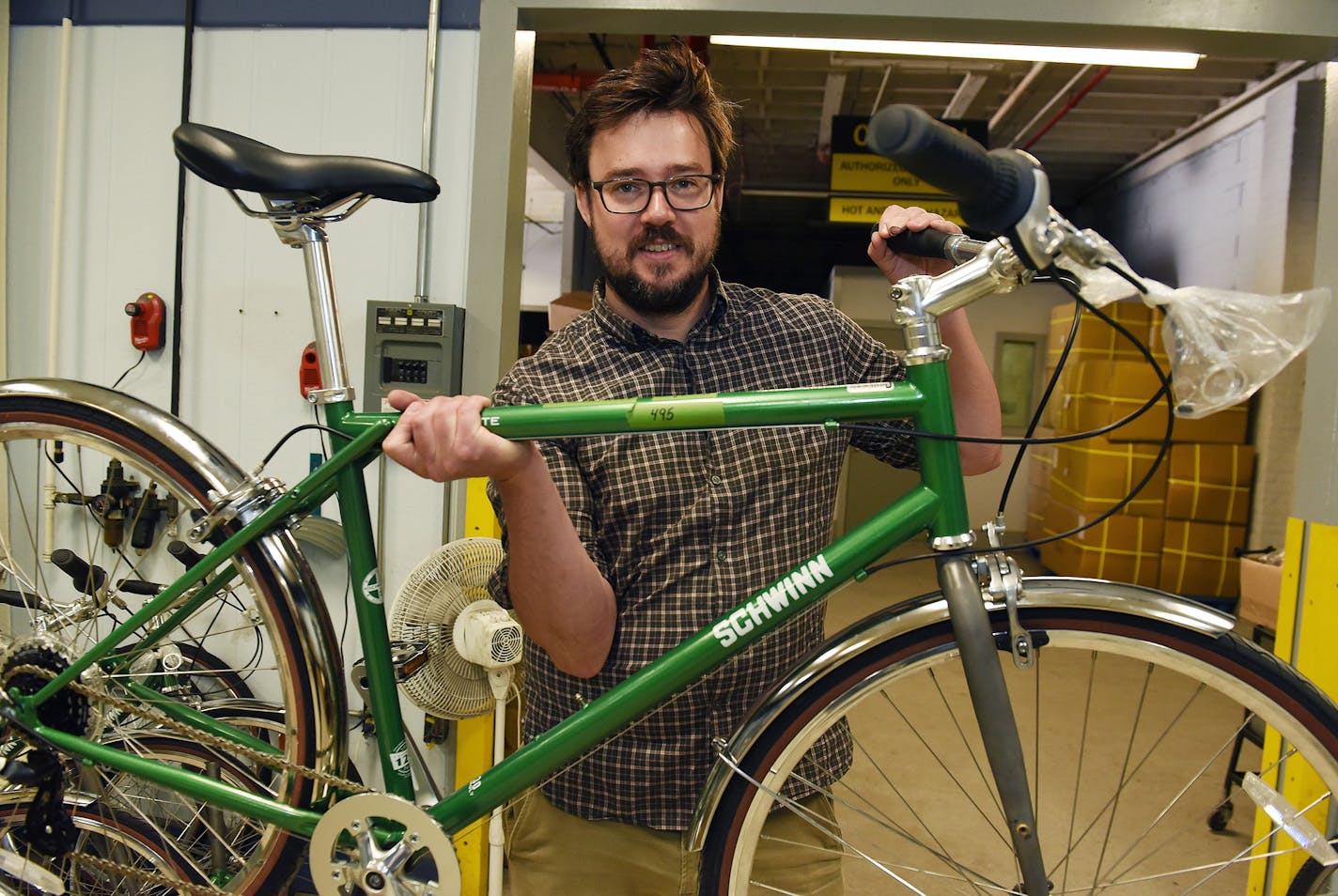 Zak Pashak, owner and founder of Detroit Bikes, holds a Schwinn bike frame on June 25, 2020, in Detroit. (Clarence Tabb, Jr./The Detroit News/TNS) ORG XMIT: 1717549