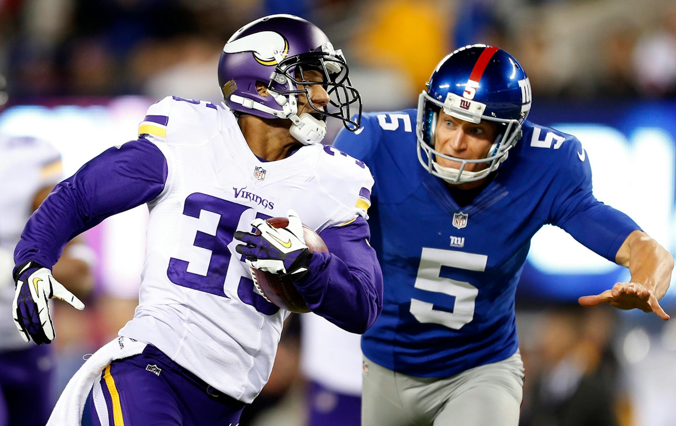 Marcus Sherels (35) ran from Giants punter Steve Weatherford (5) as he returned a punt 86 yards for a touchdown in the first quarter. He leads the NFL with 16.3 yards per punt return, including this TD.